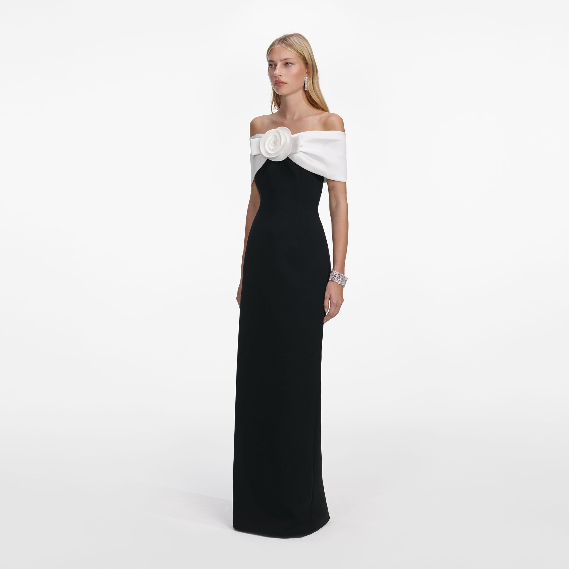 Side view of a woman wearing the Black Crepe Flower Maxi Dress