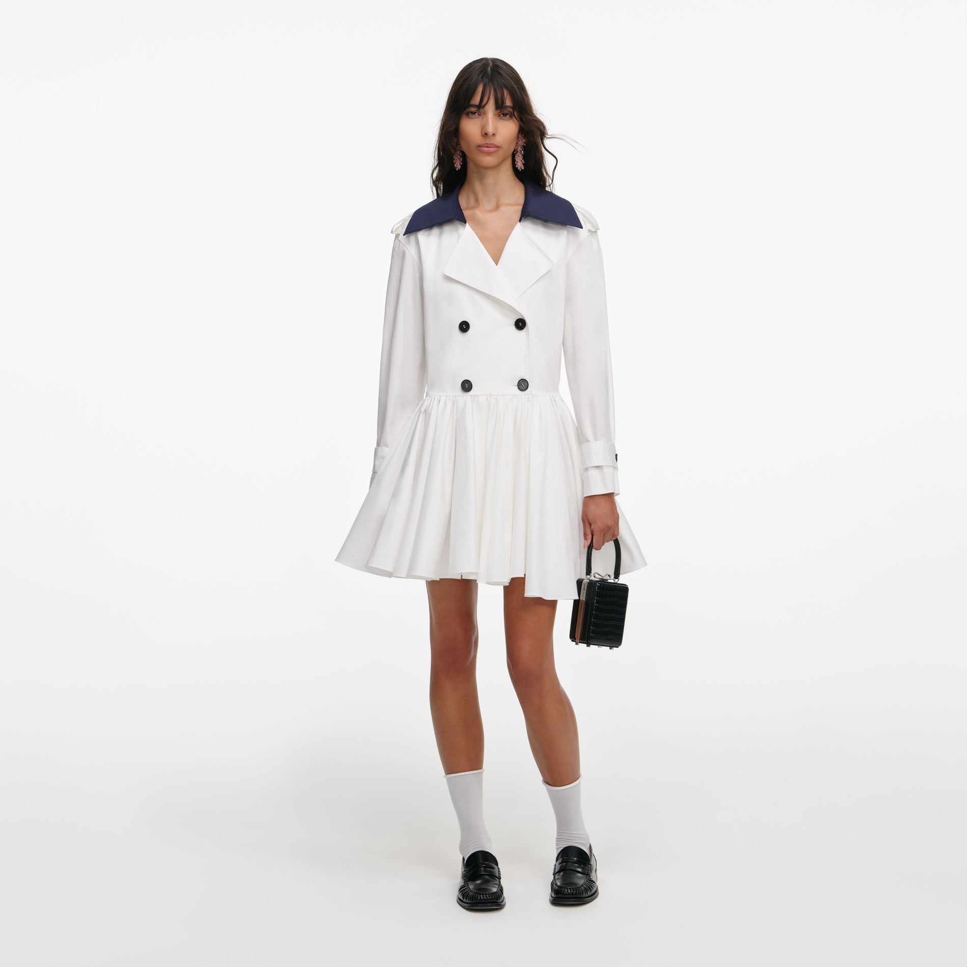 Front view of a woman wearing the White Cotton Double Breasted Mini Dress