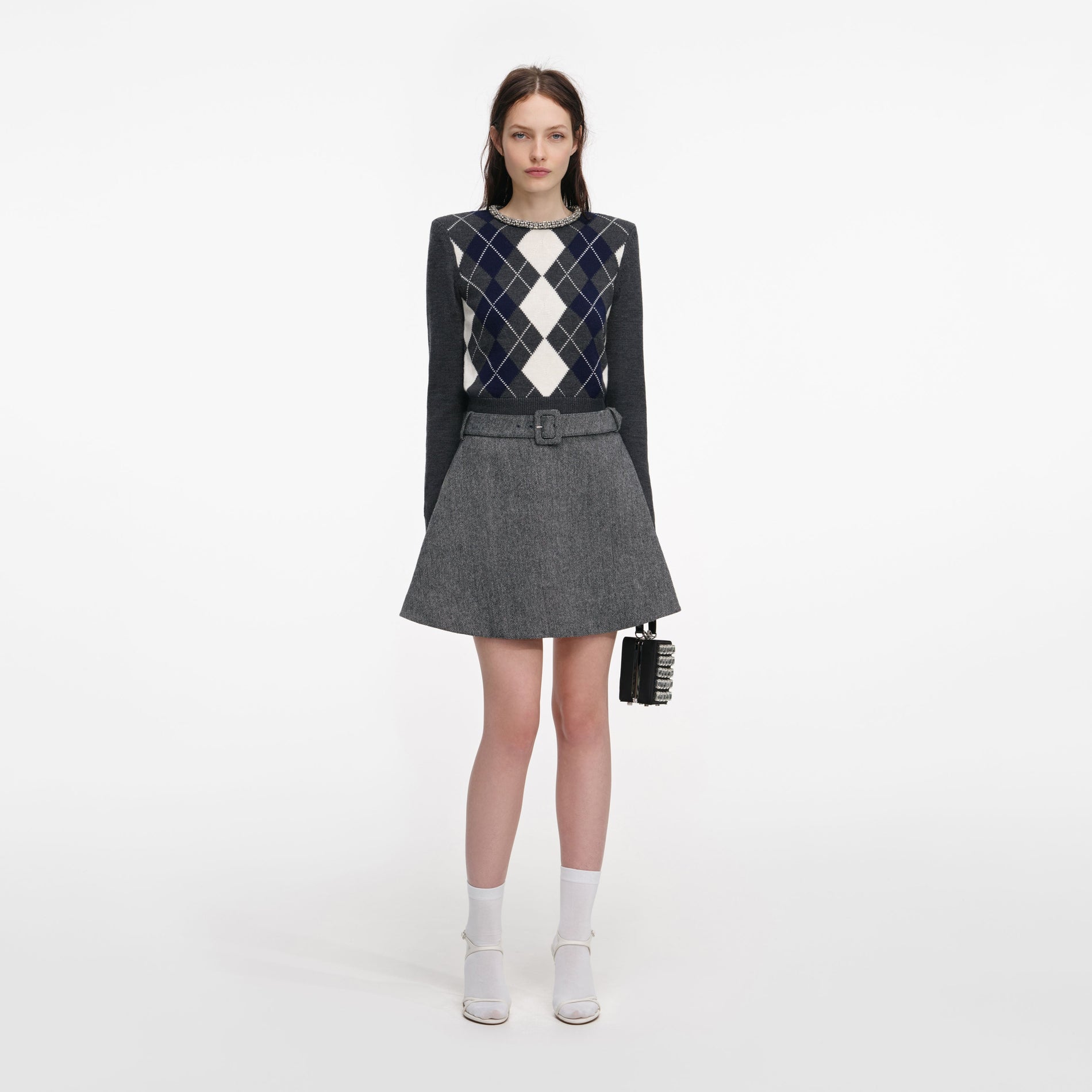 Front view of a woman wearing the Grey Herringbone Flared Mini Skirt