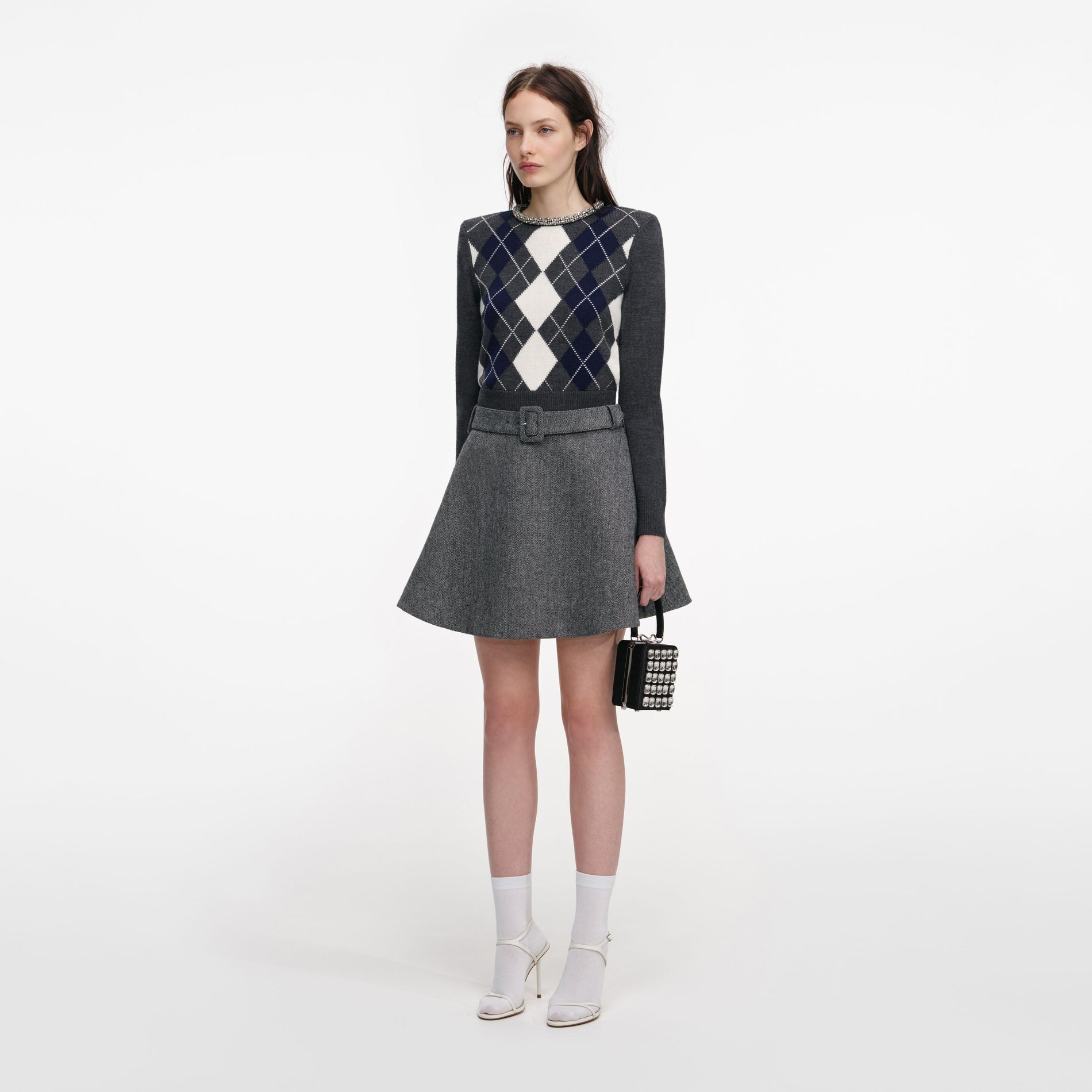 Side view of a woman wearing the Grey Herringbone Flared Mini Skirt