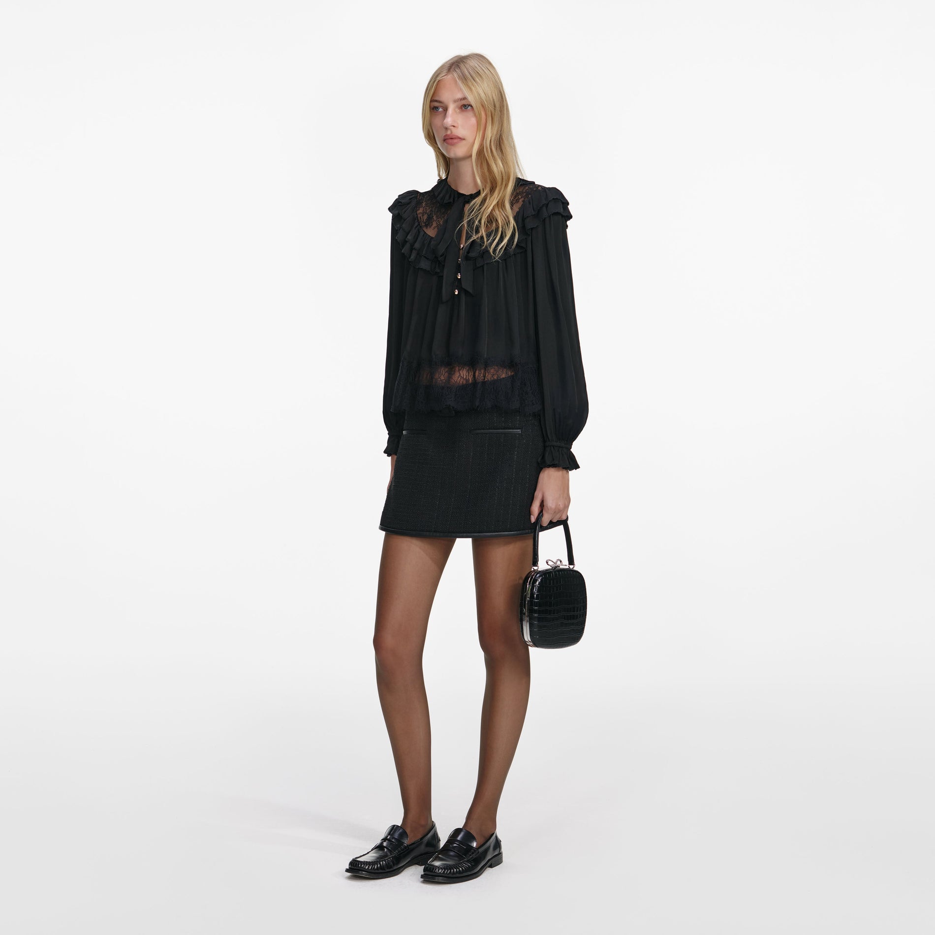 Side view of a woman wearing the Black Viscose Lace Blouse