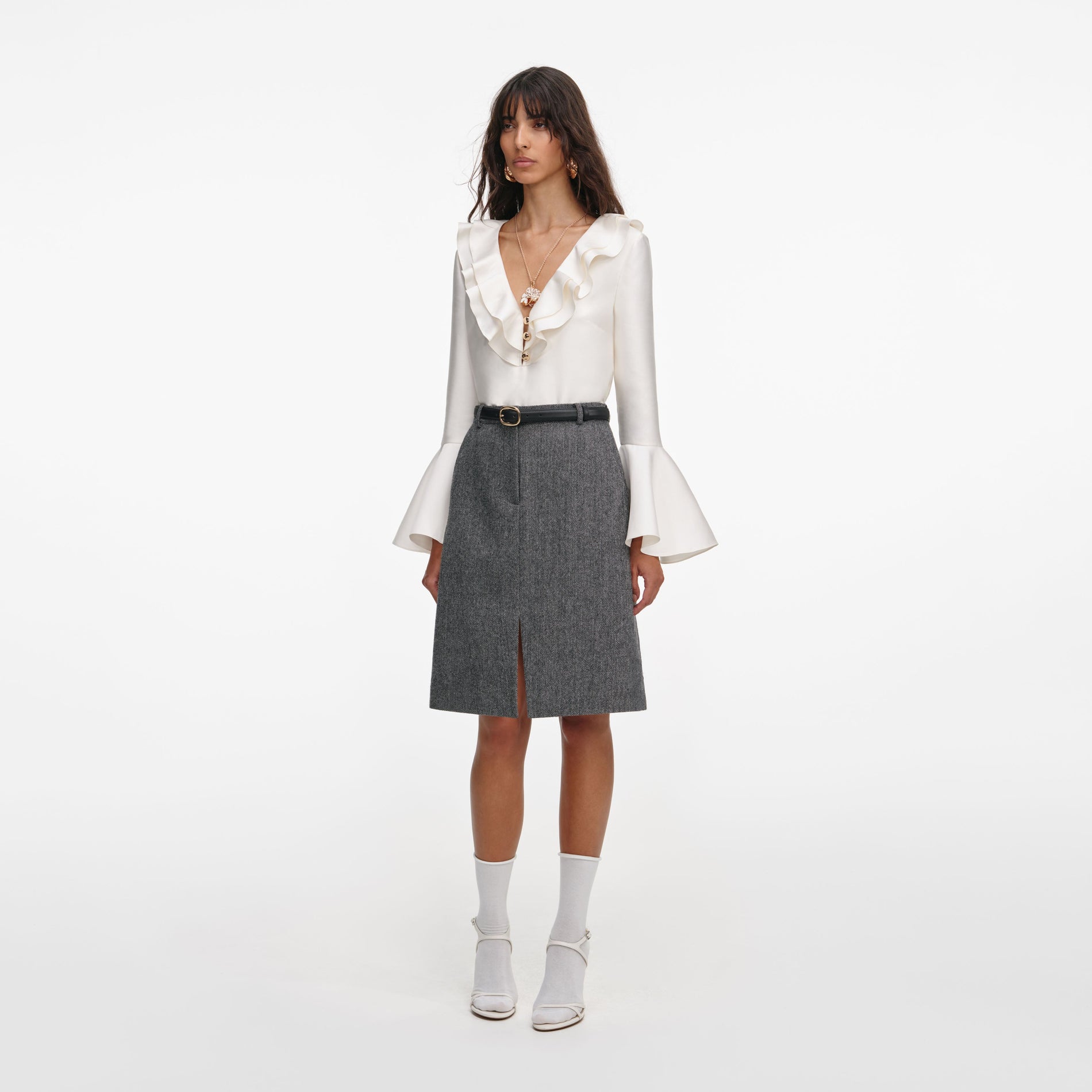 A close up of a woman wearing the Grey Herringbone Midi Skirt