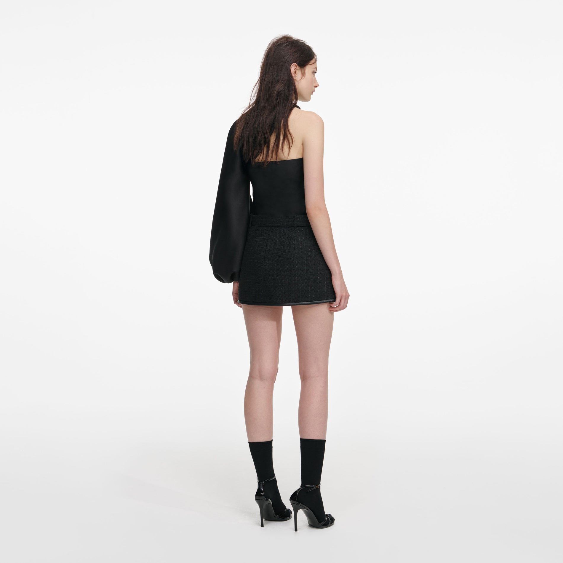 Back view of a woman wearing the Black Taffeta Draped Sleeve Top