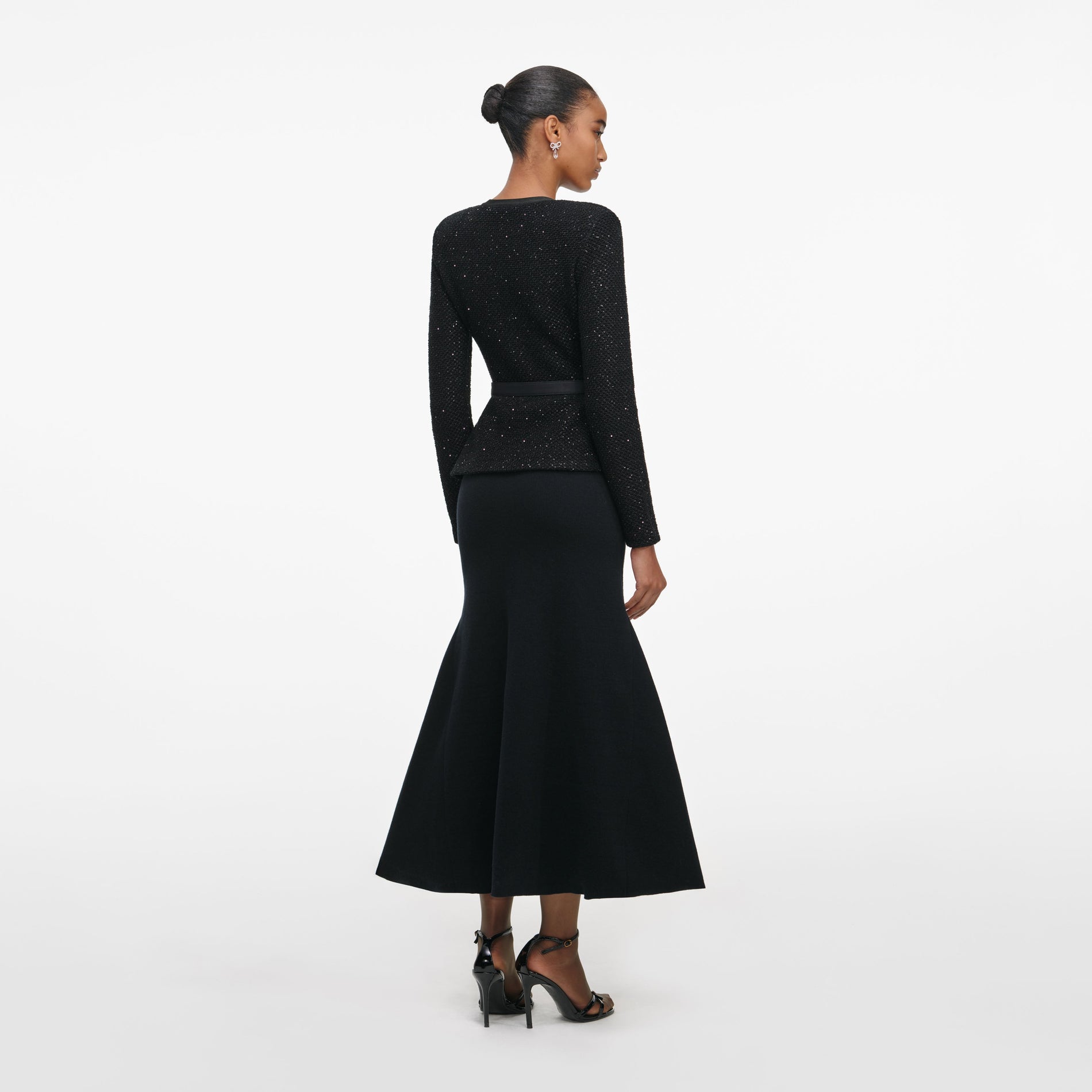 Back view of a woman wearing the Black Sequin Knit Tailored Midi Dress
