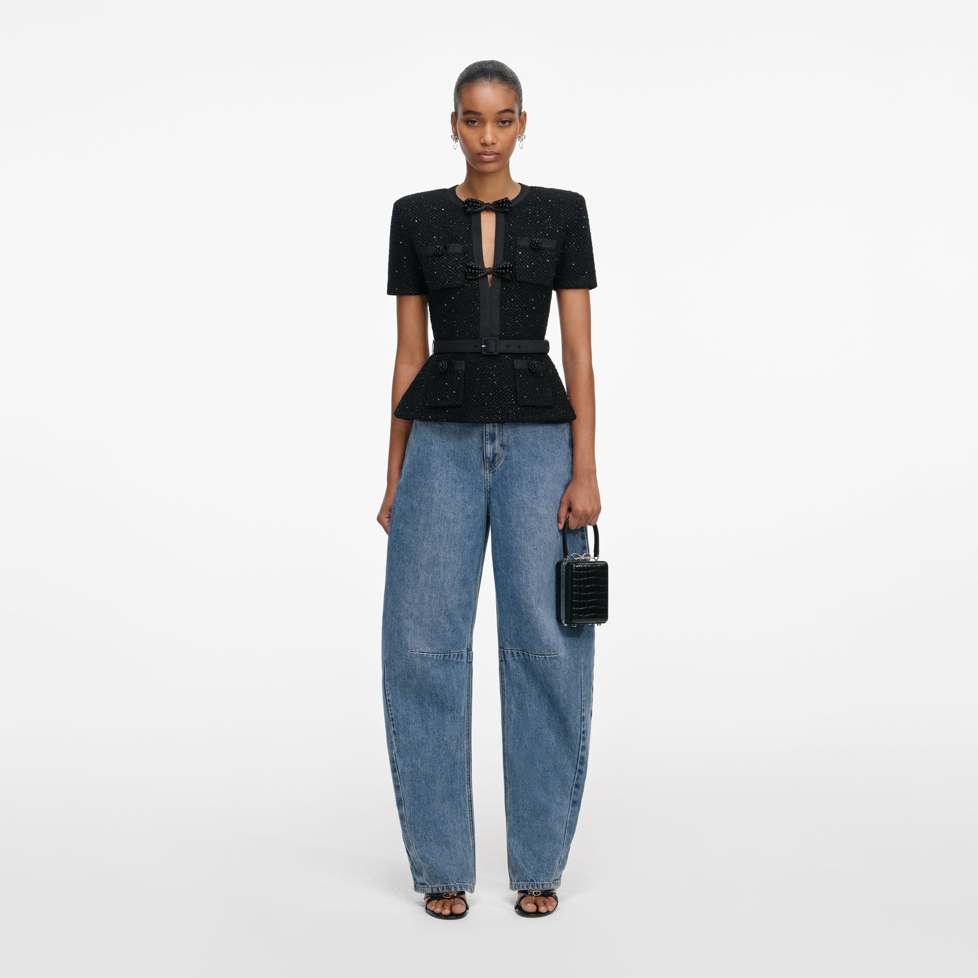 Front view of a woman wearing the Black Sequin Knit Top