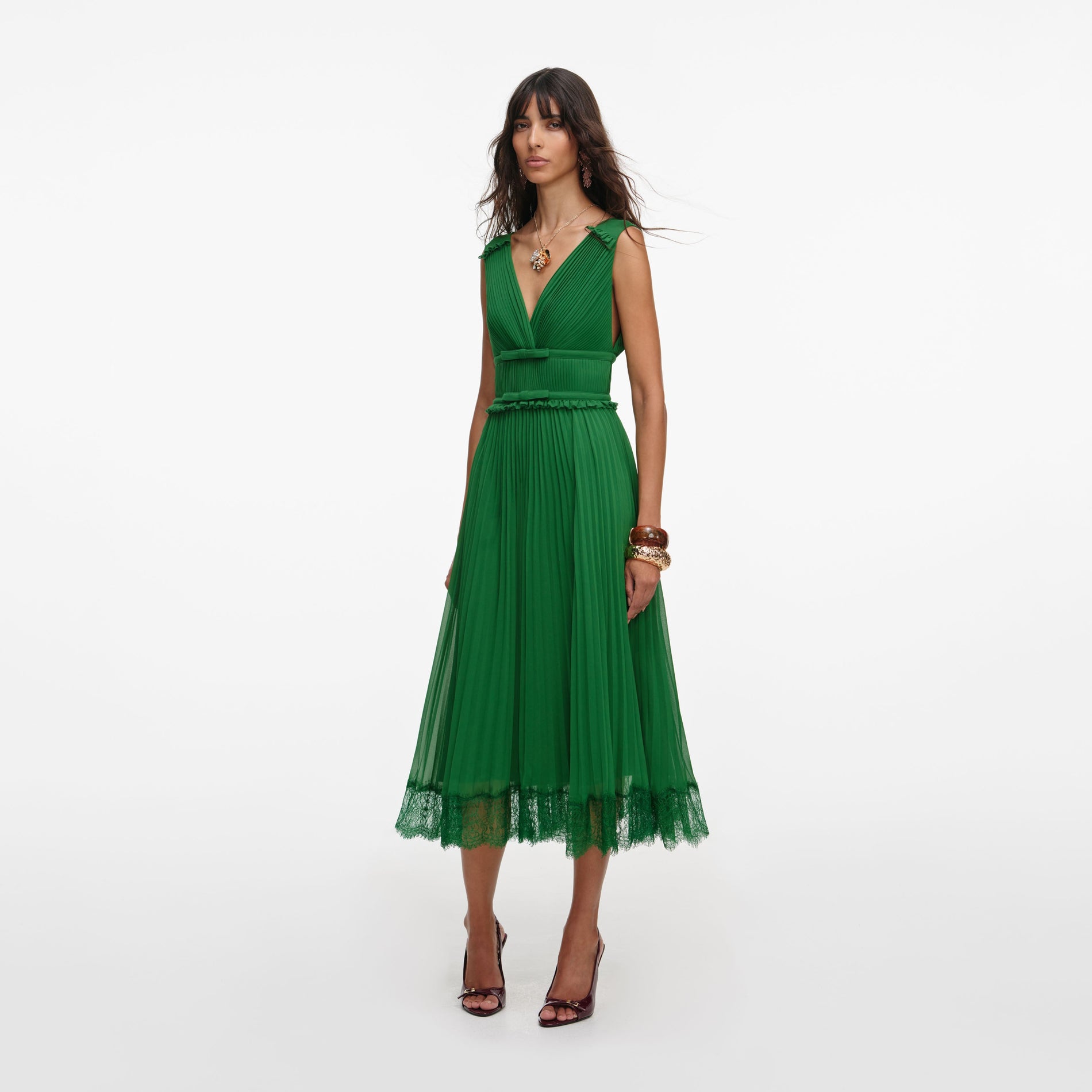 Side view of a woman wearing the Green Chiffon Midi Dress