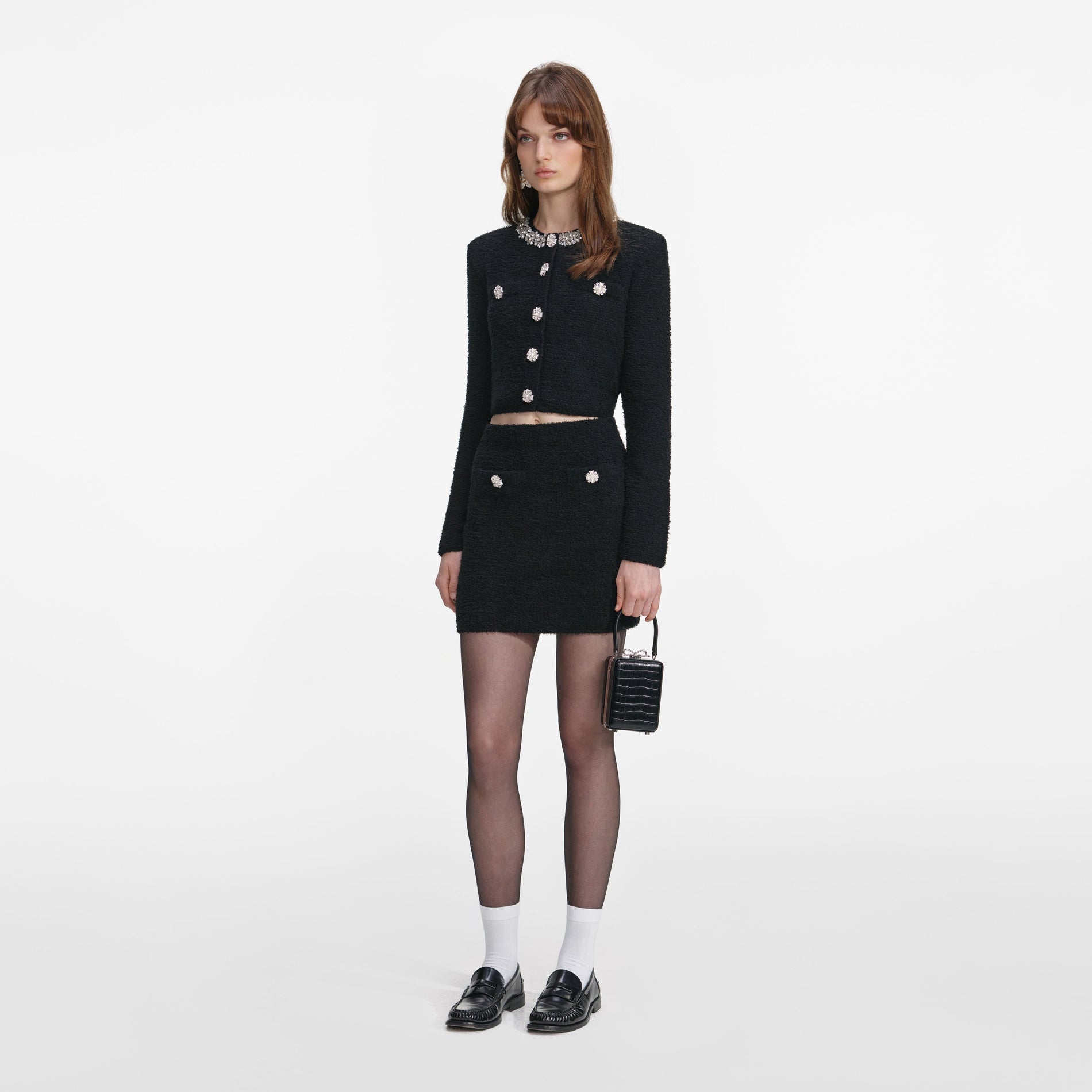 Side view of a woman wearing the Black Knit Mini Skirt