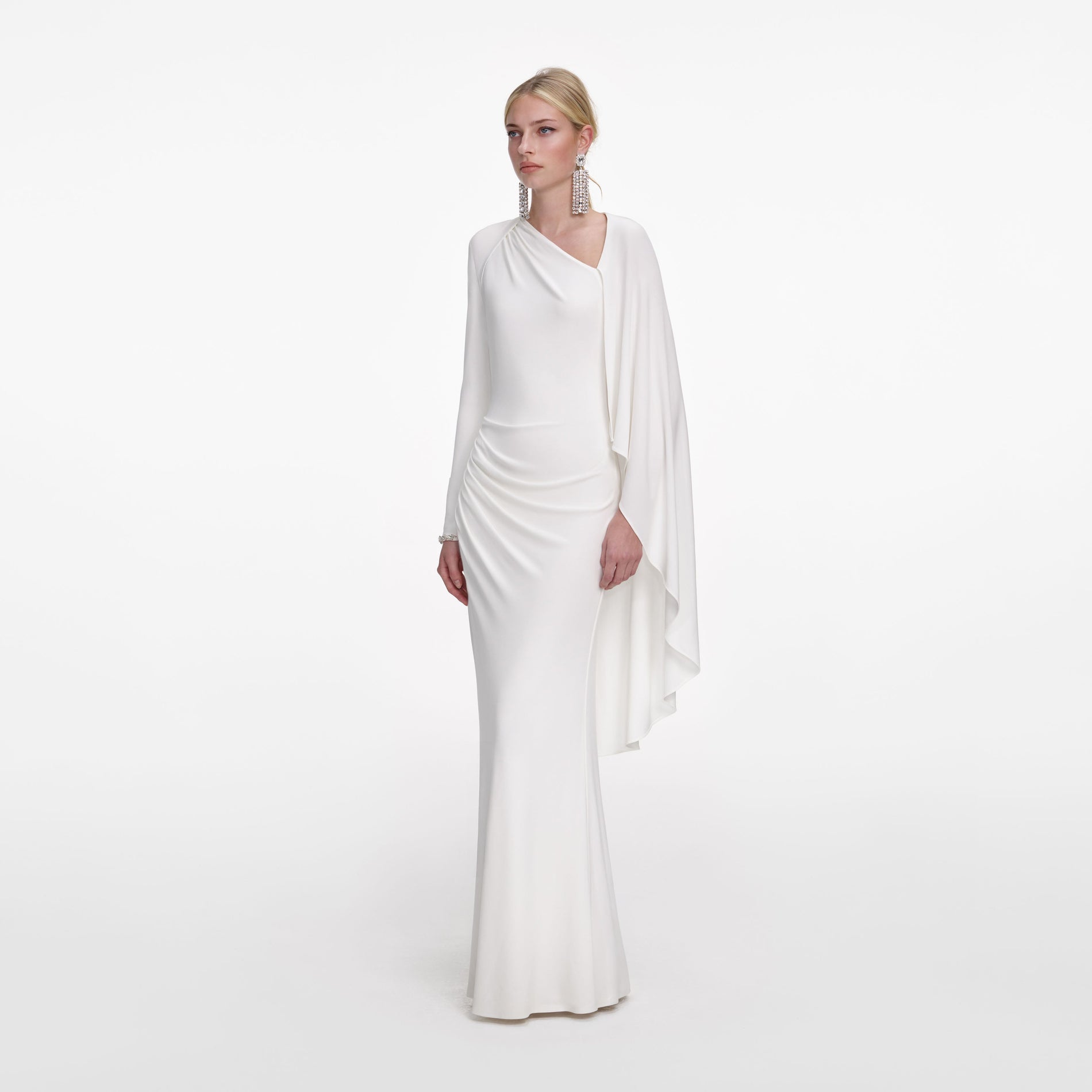 Side view of a woman wearing the White Jersey Drape Maxi Dress