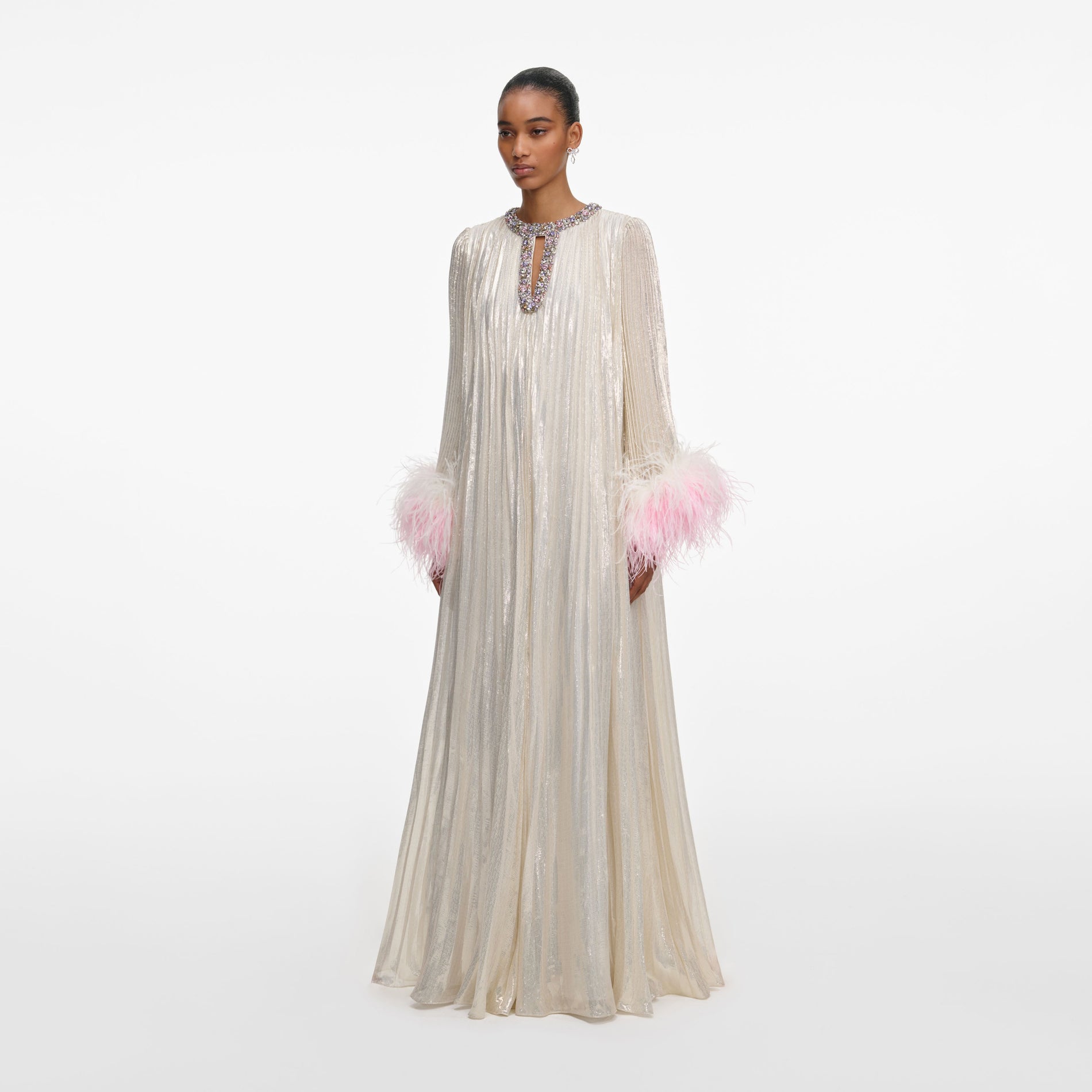 Side view of a woman wearing the Champagne Metallic Ombre Feather Maxi Dress
