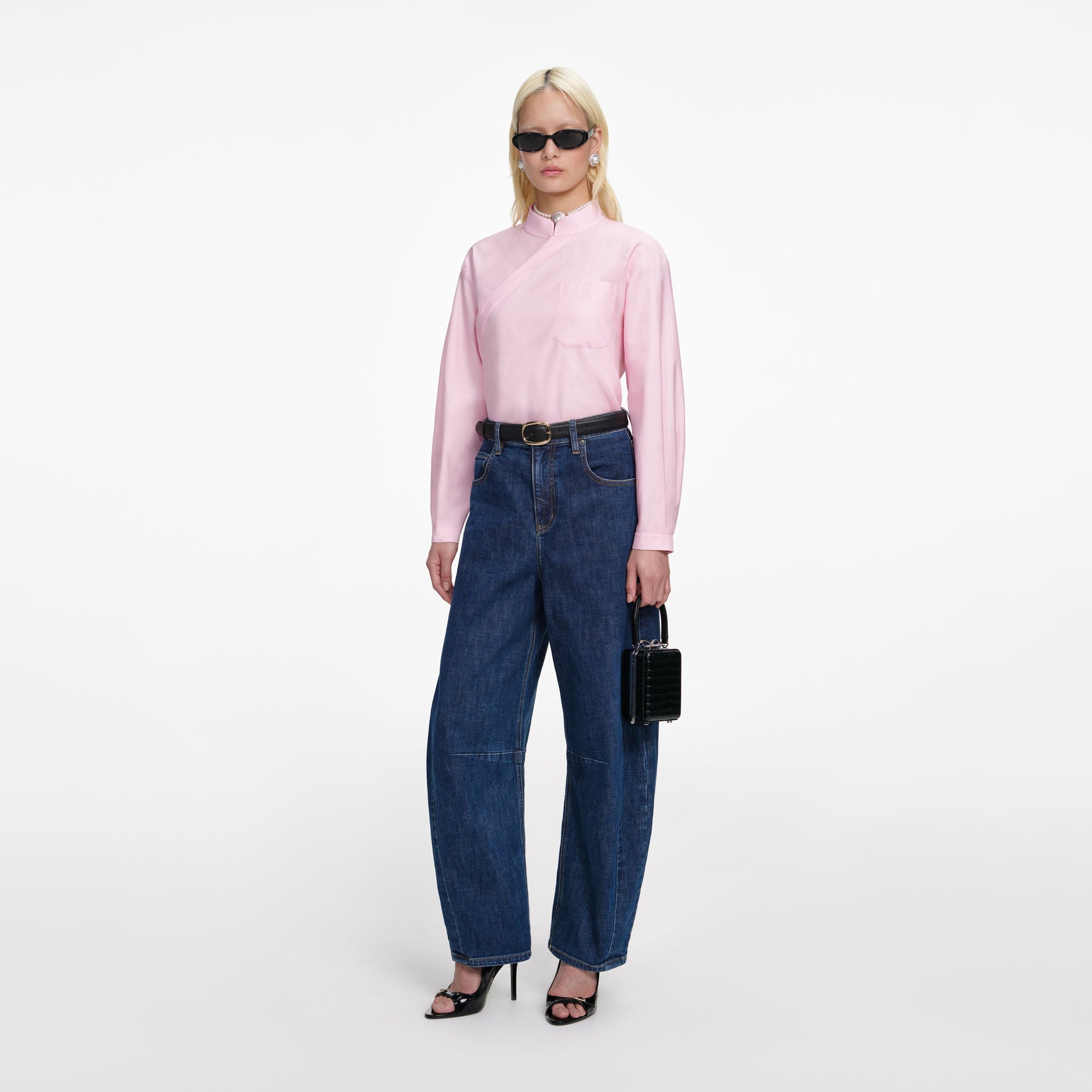 Side view of a woman wearing the Pink Cotton Asymmetric Shirt