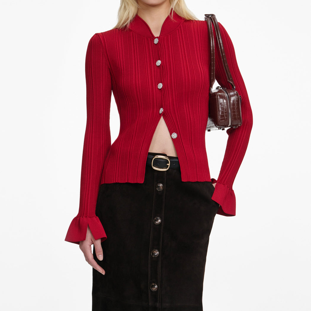 A close up of a woman wearing the Red Viscose Cardigan