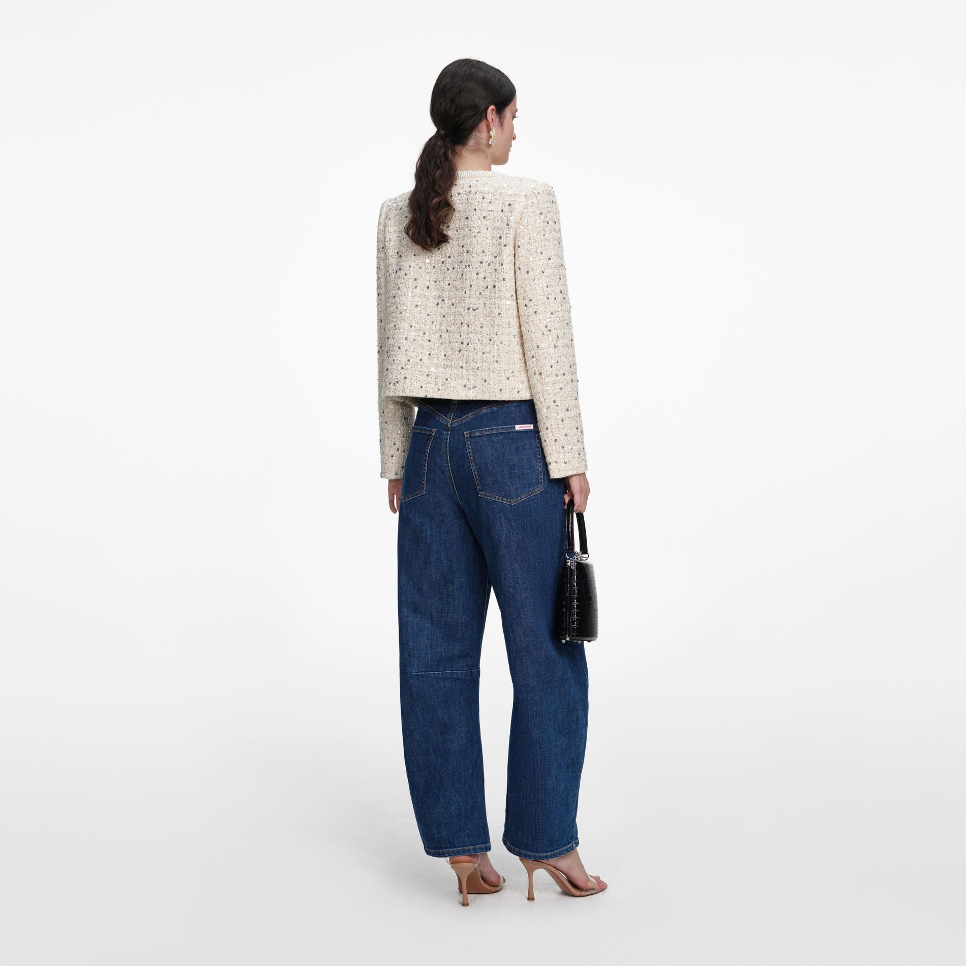 Back view of a woman wearing the Cream Embellished Boucle Jacket