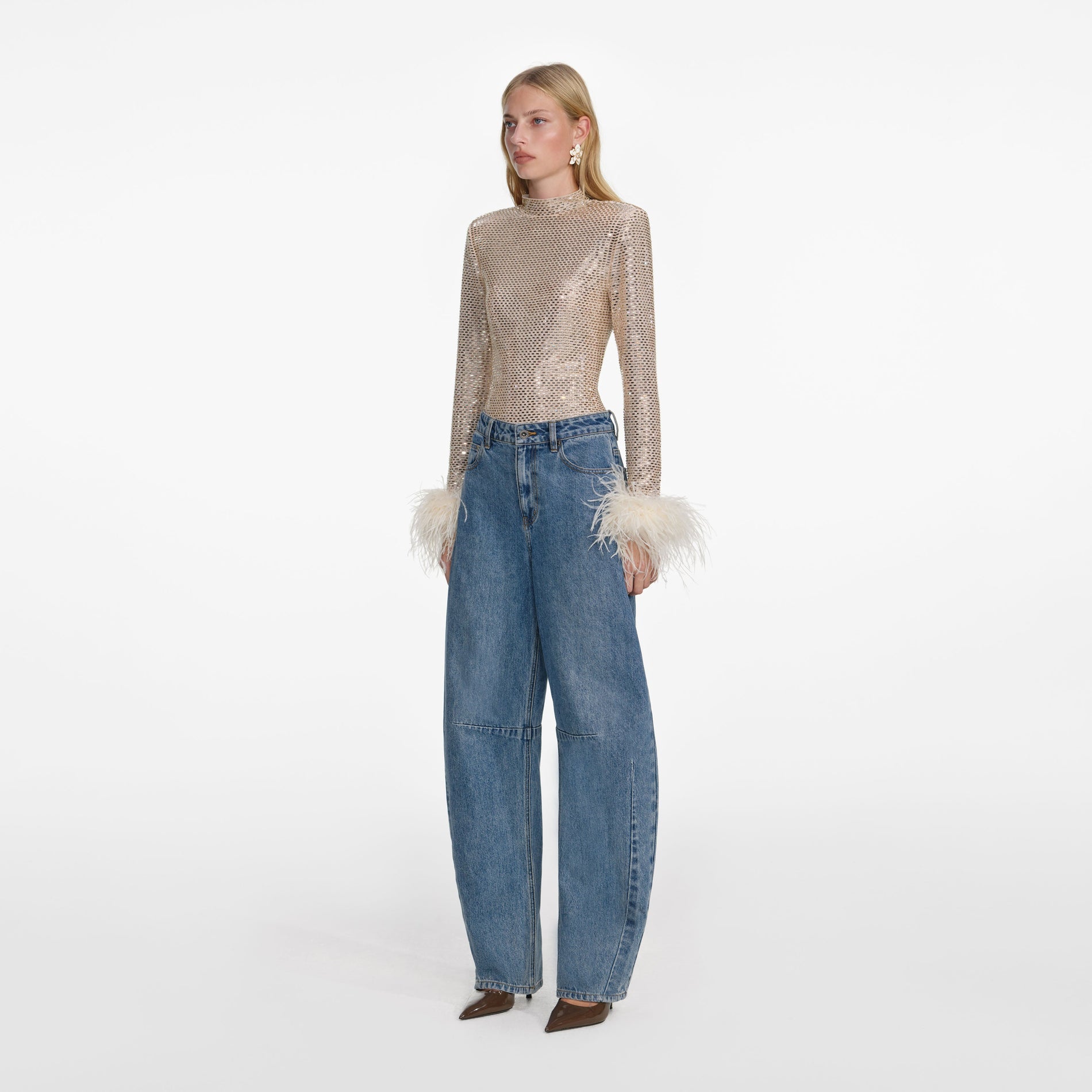 Side view of a woman wearing the Champagne Rhinestone Feather Top