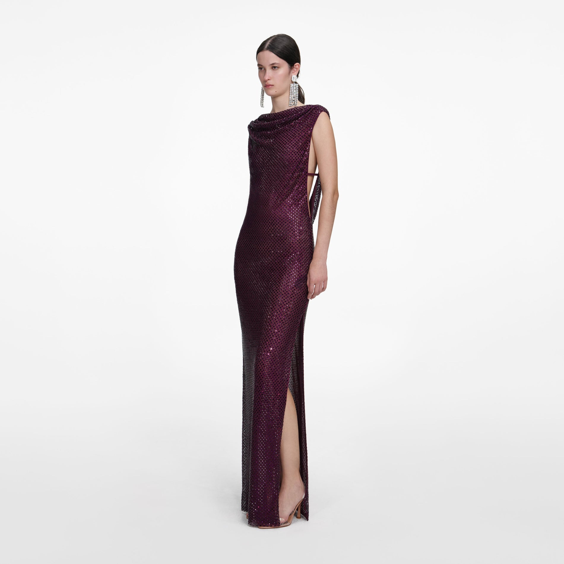 Side view of a woman wearing the Burgundy Rhinestone Drape Maxi Dress