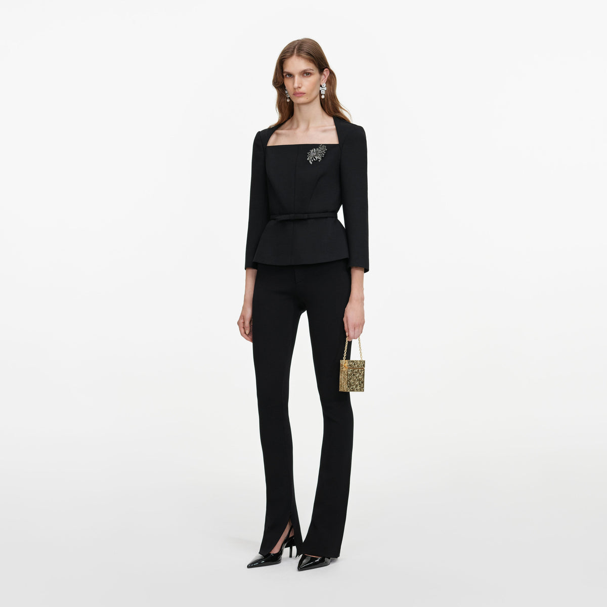 Side view of a woman wearing the Black Tailored Brooch Top