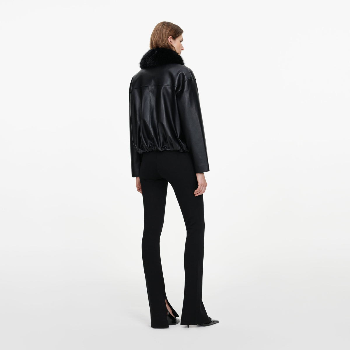 Back view of a woman wearing the Black Faux Leather Bomber Jacket