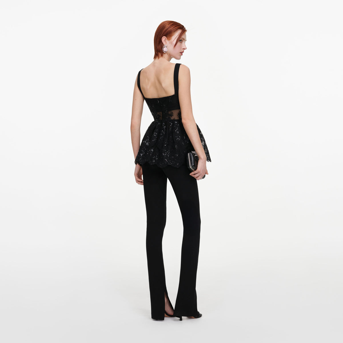 Back view of a woman wearing the Black Lace Peplum Top