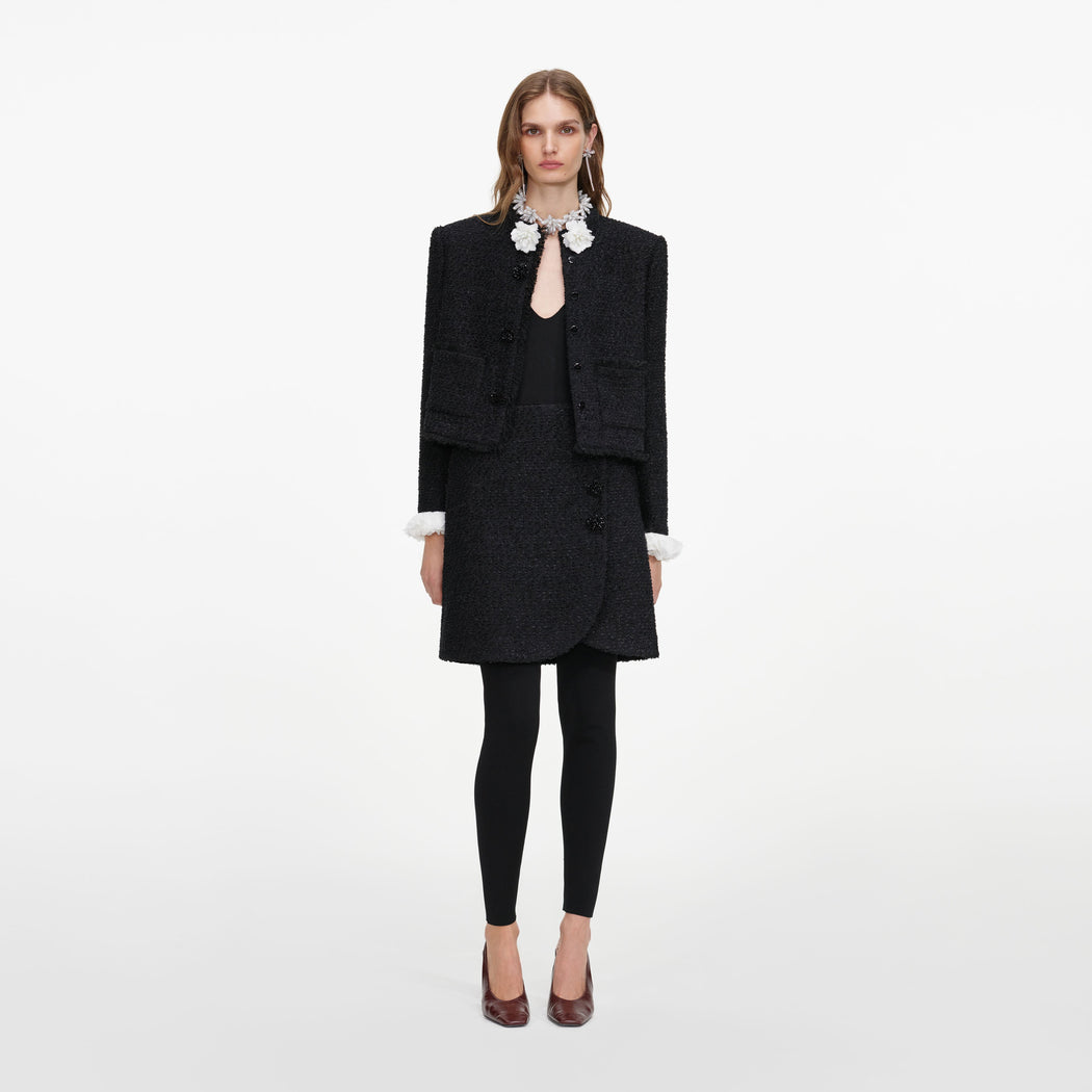 Front view of a woman wearing the Black Boucle Flower Jacket