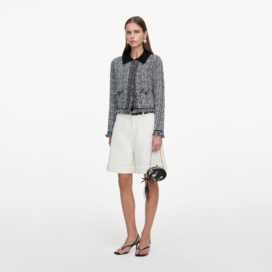 Side view of a woman wearing the Cream Sequin Boucle Tailored Shorts