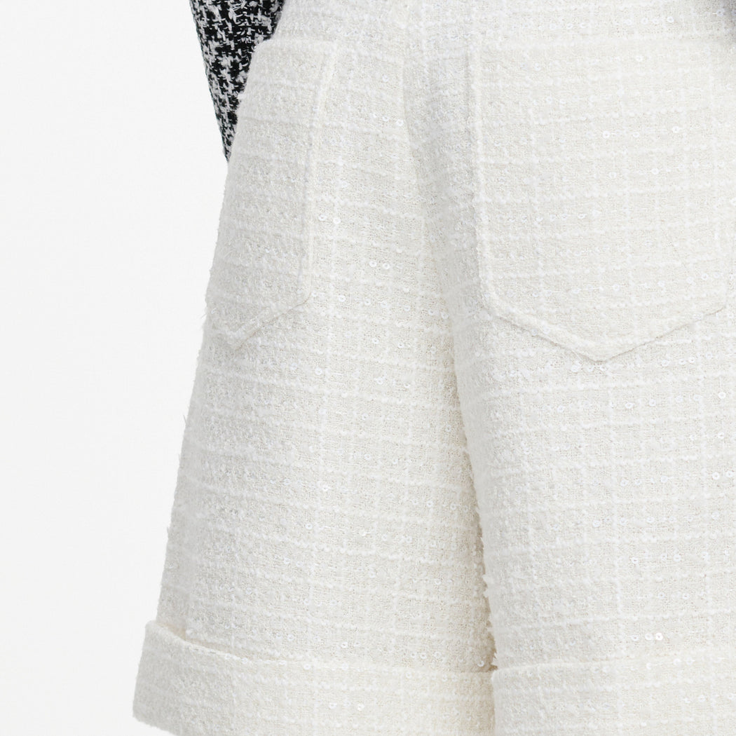 A close up of the fabric for the Cream Sequin Boucle Tailored Shorts