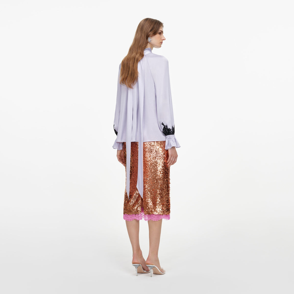 Back view of a woman wearing the Lilac Viscose Contrast Lace Blouse