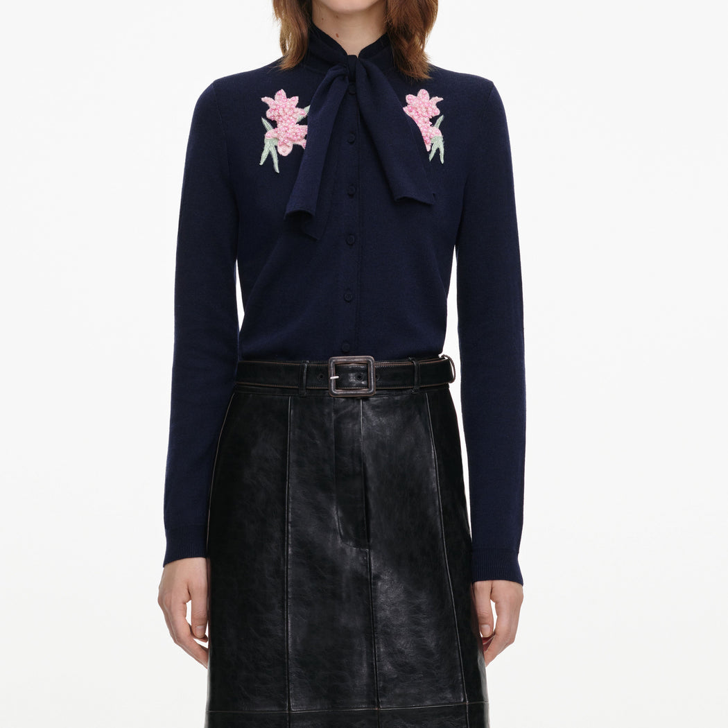 A close up of a woman wearing the Navy Sequin Embellished Knit Cardigan
