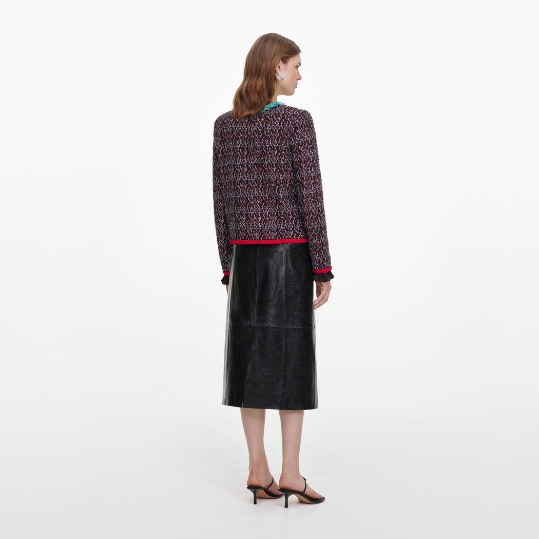 Back view of a woman wearing the Black Belted Faux Leather Midi Skirt