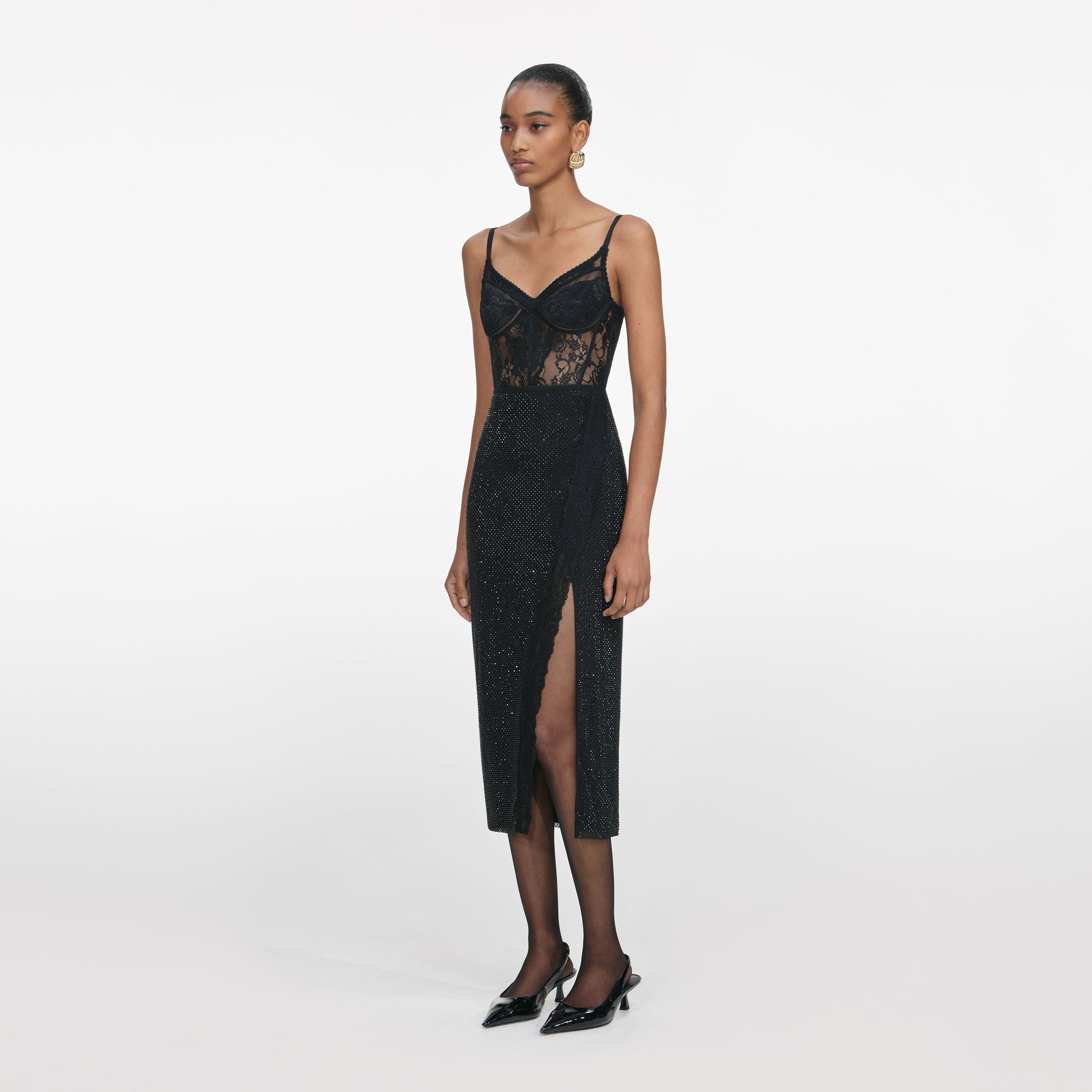 Side view of a woman wearing the Black Rhinestone Midi Skirt