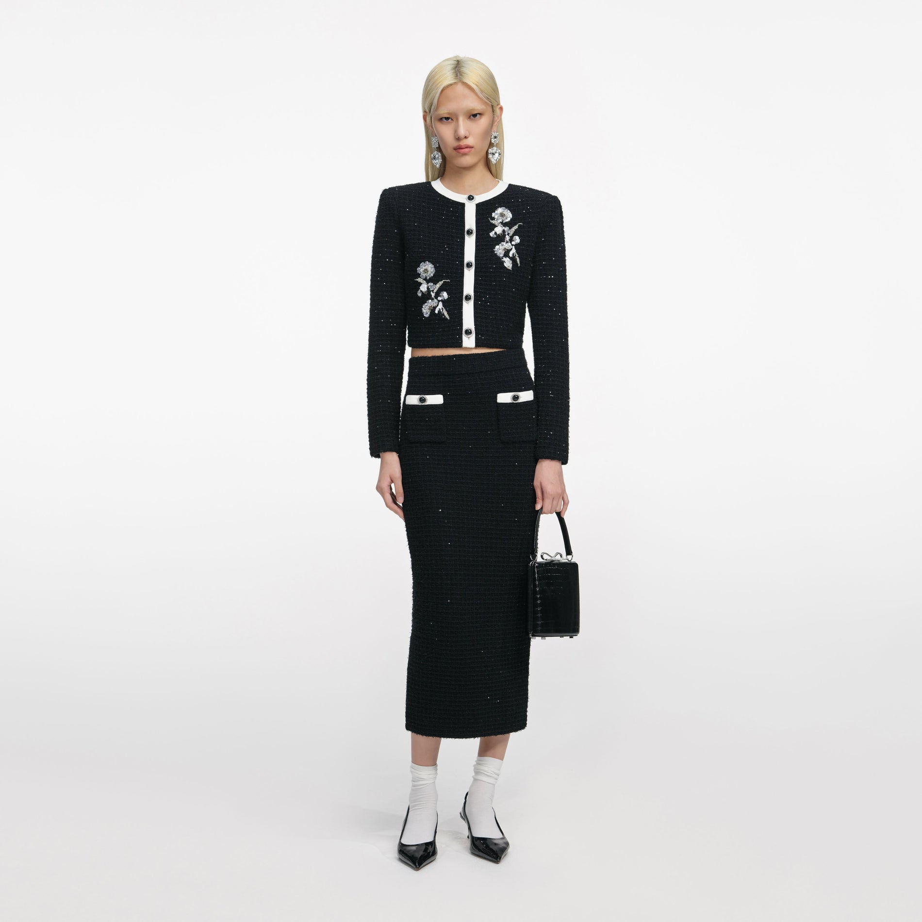 Front view of a woman wearing the Black Textured Knit Midi Skirt