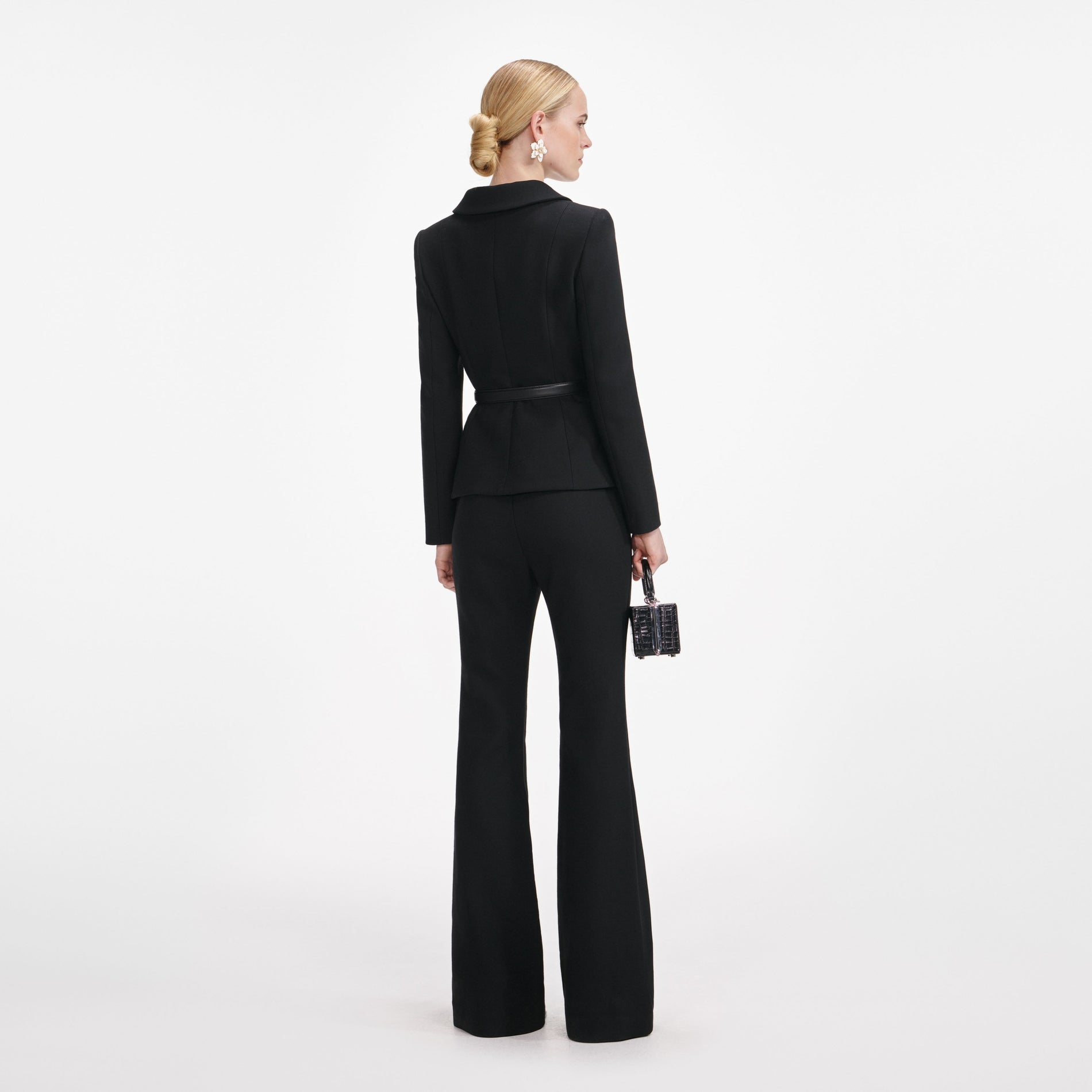Back view of a woman wearing the Black Wool Double Breasted Jumpsuit