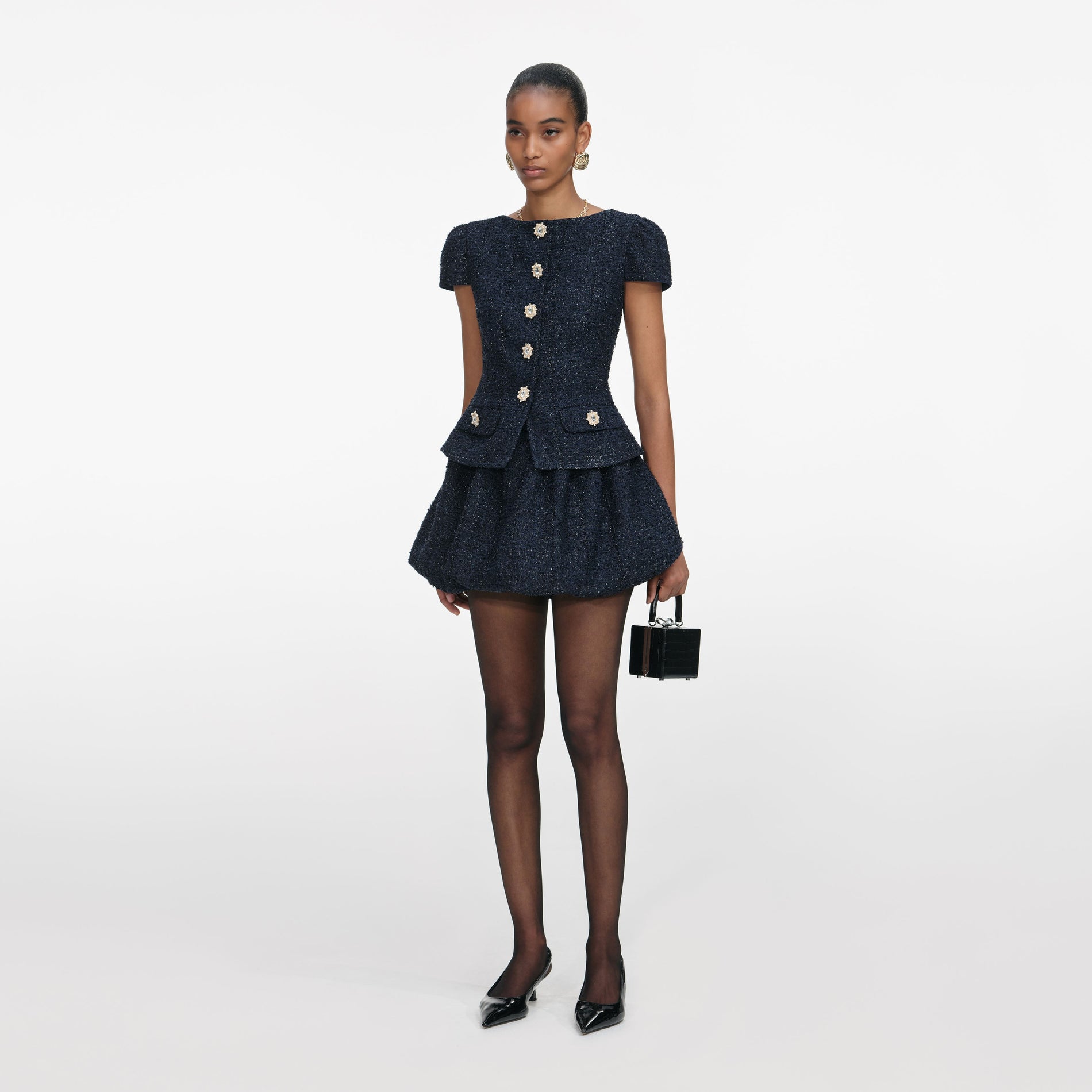 Side view of a woman wearing the Navy Boucle Mini Dress
