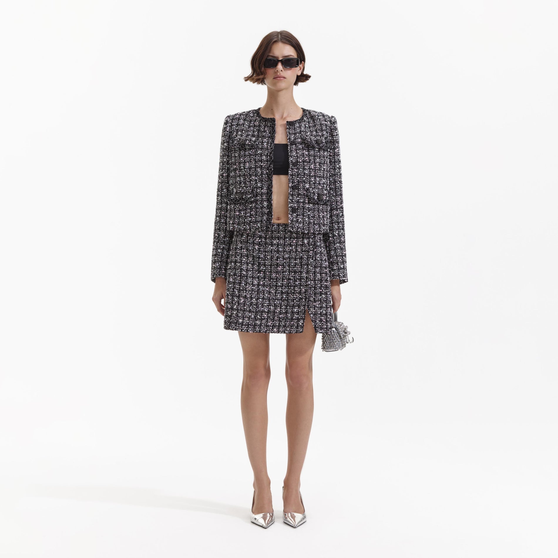 Front view of a woman wearing the Black Check Boucle Mini Skirt