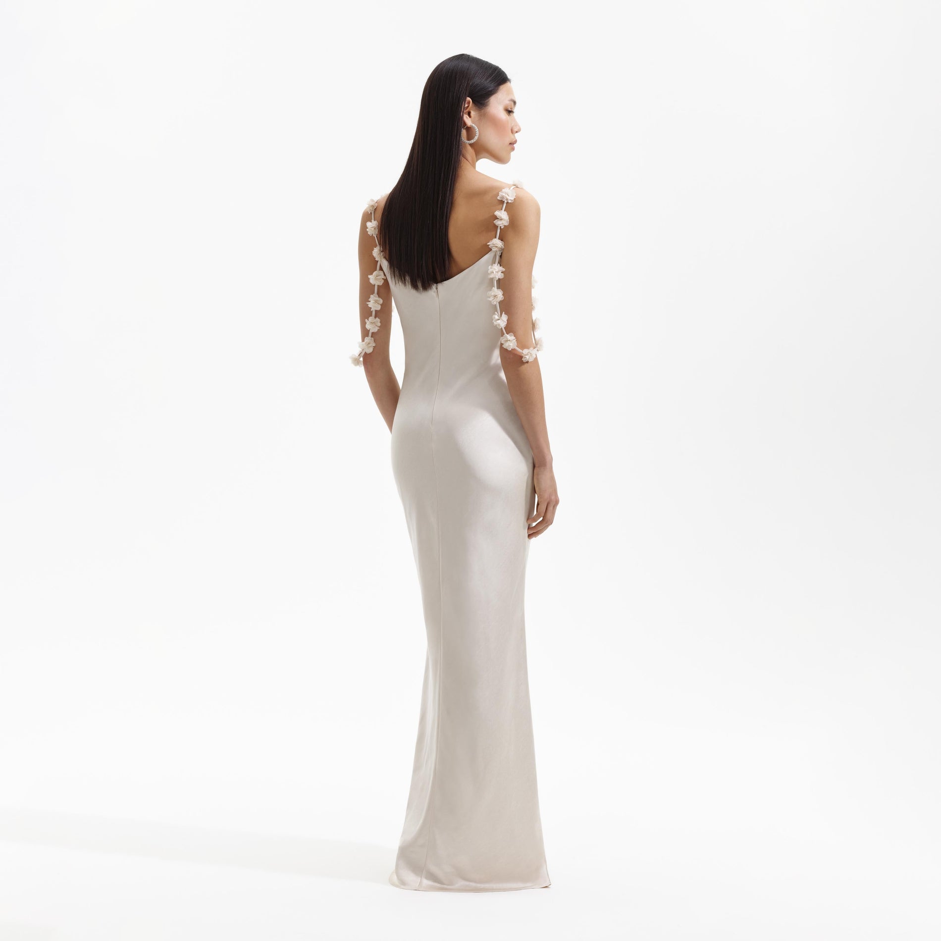 Back view of a woman wearing the Champagne Satin Flower Maxi Dress