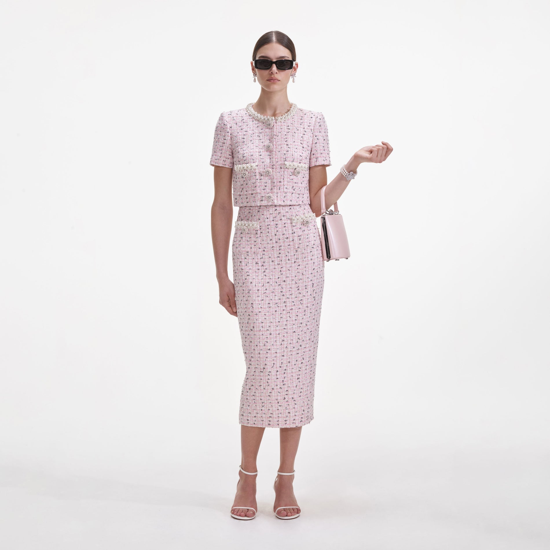 Front view of a woman wearing the Pink Boucle Pearl Midi Skirt