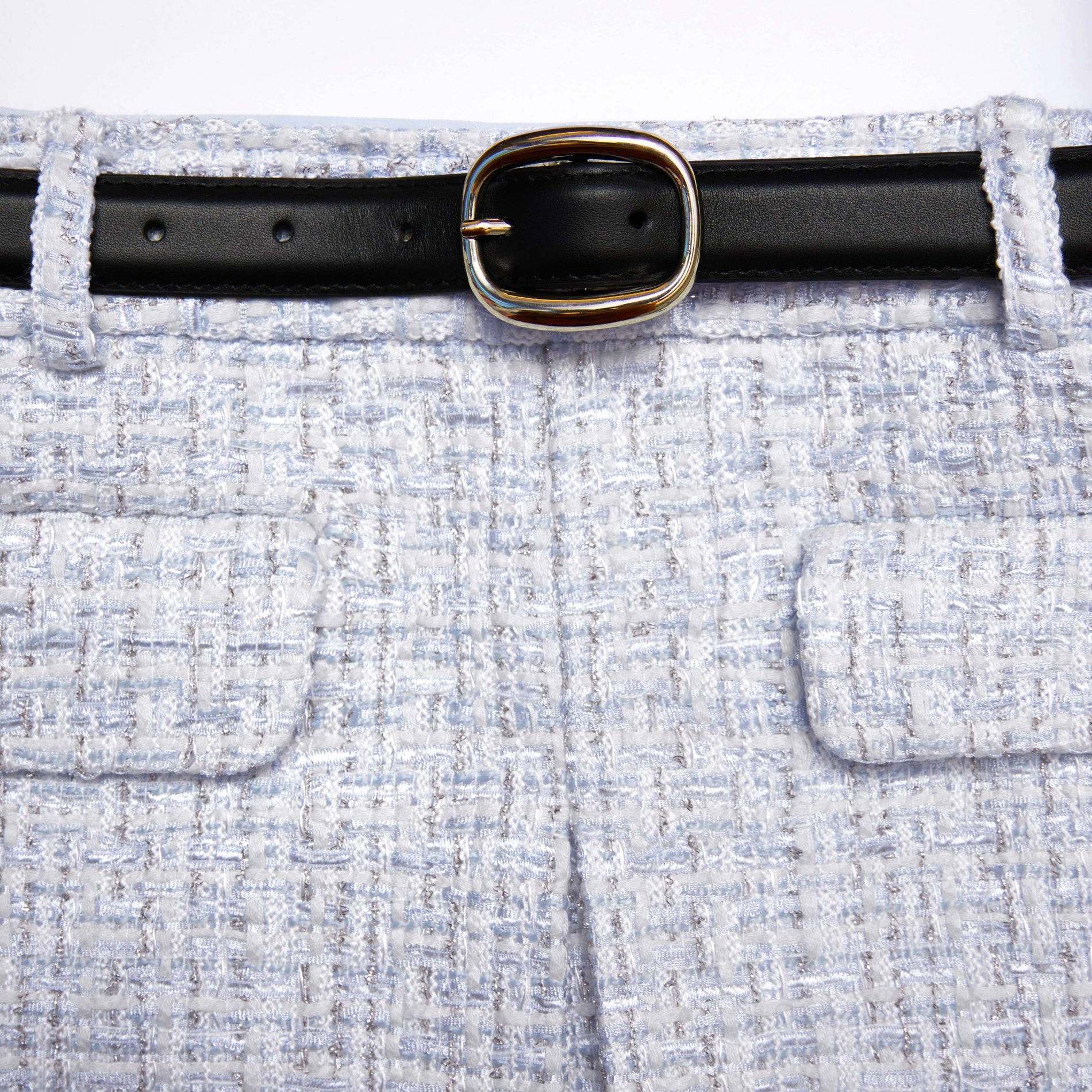 Side view of a woman wearing the Blue Boucle Mini Skirt