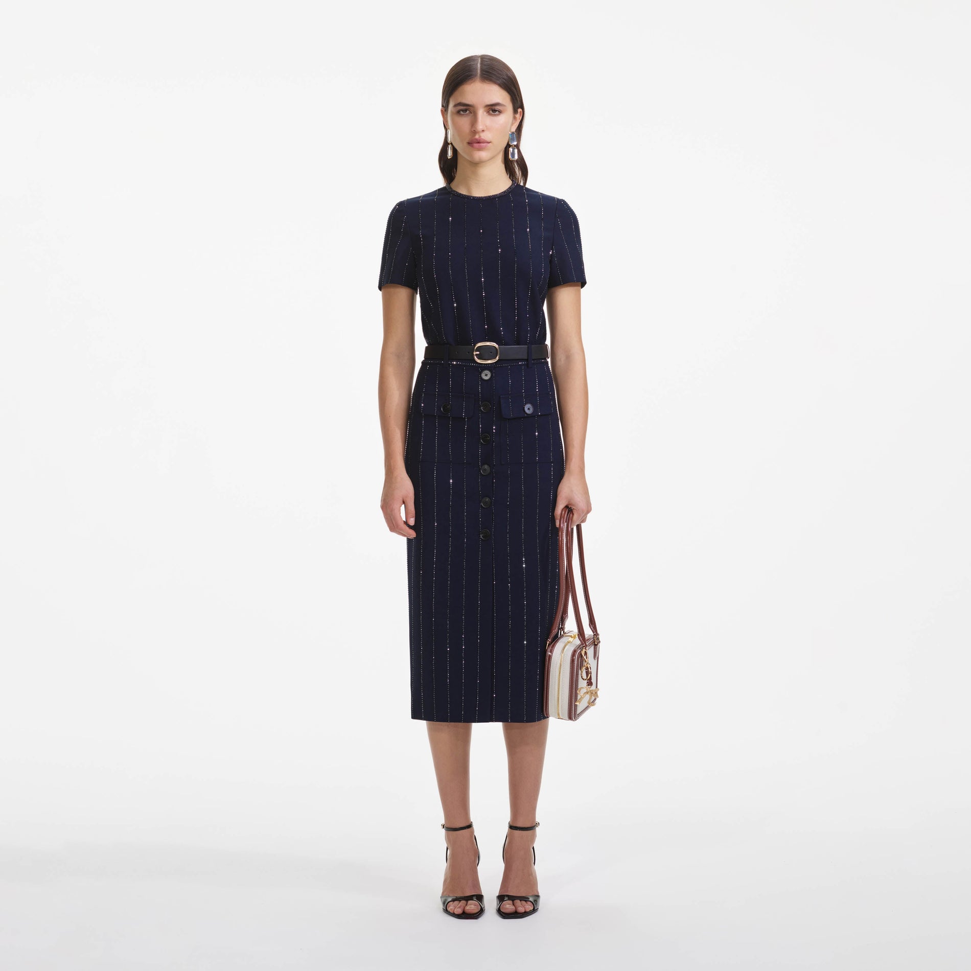 Front view of a woman wearing the Navy Rhinestone Pinstripe Midi Skirt