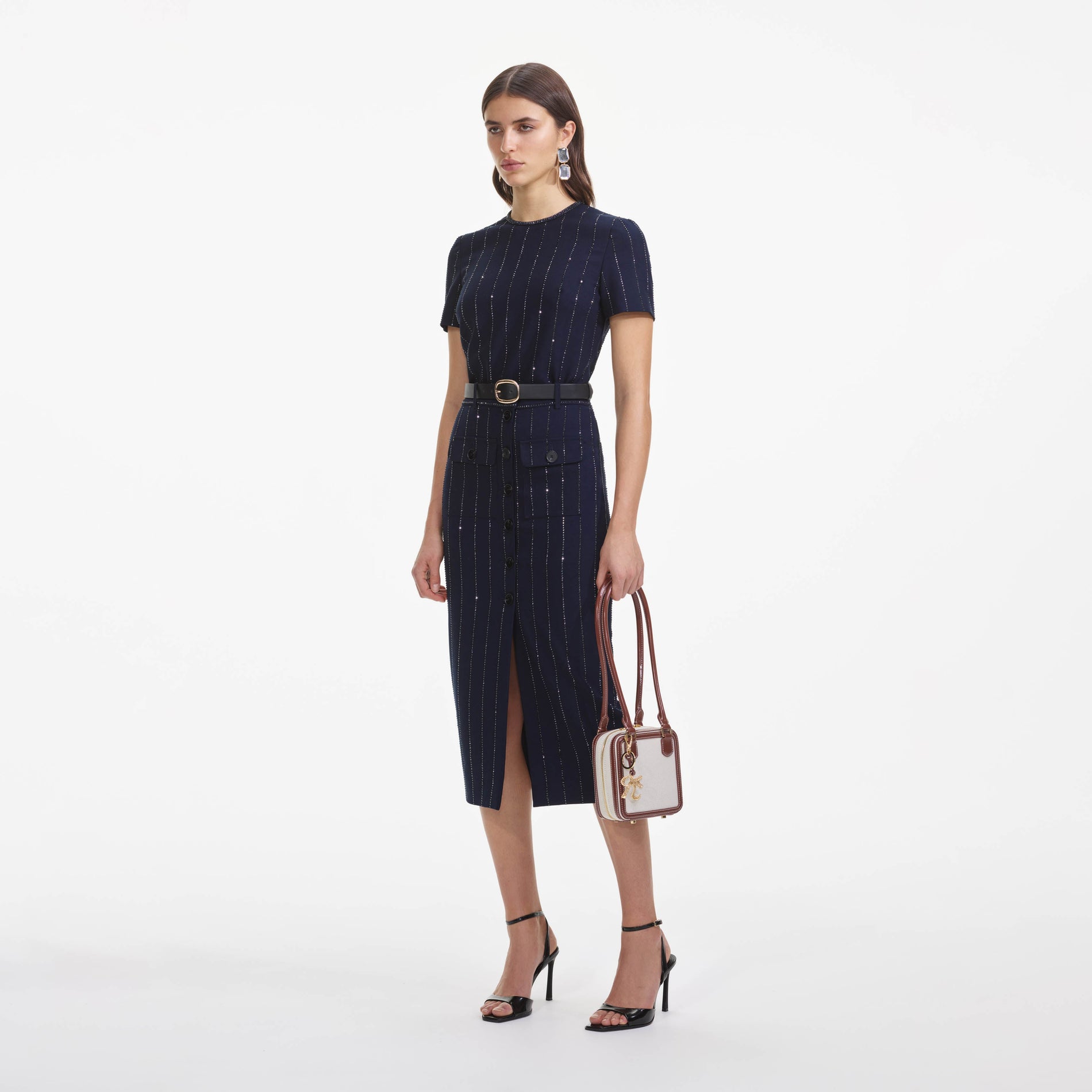 Side view of a woman wearing the Navy Rhinestone Pinstripe Top