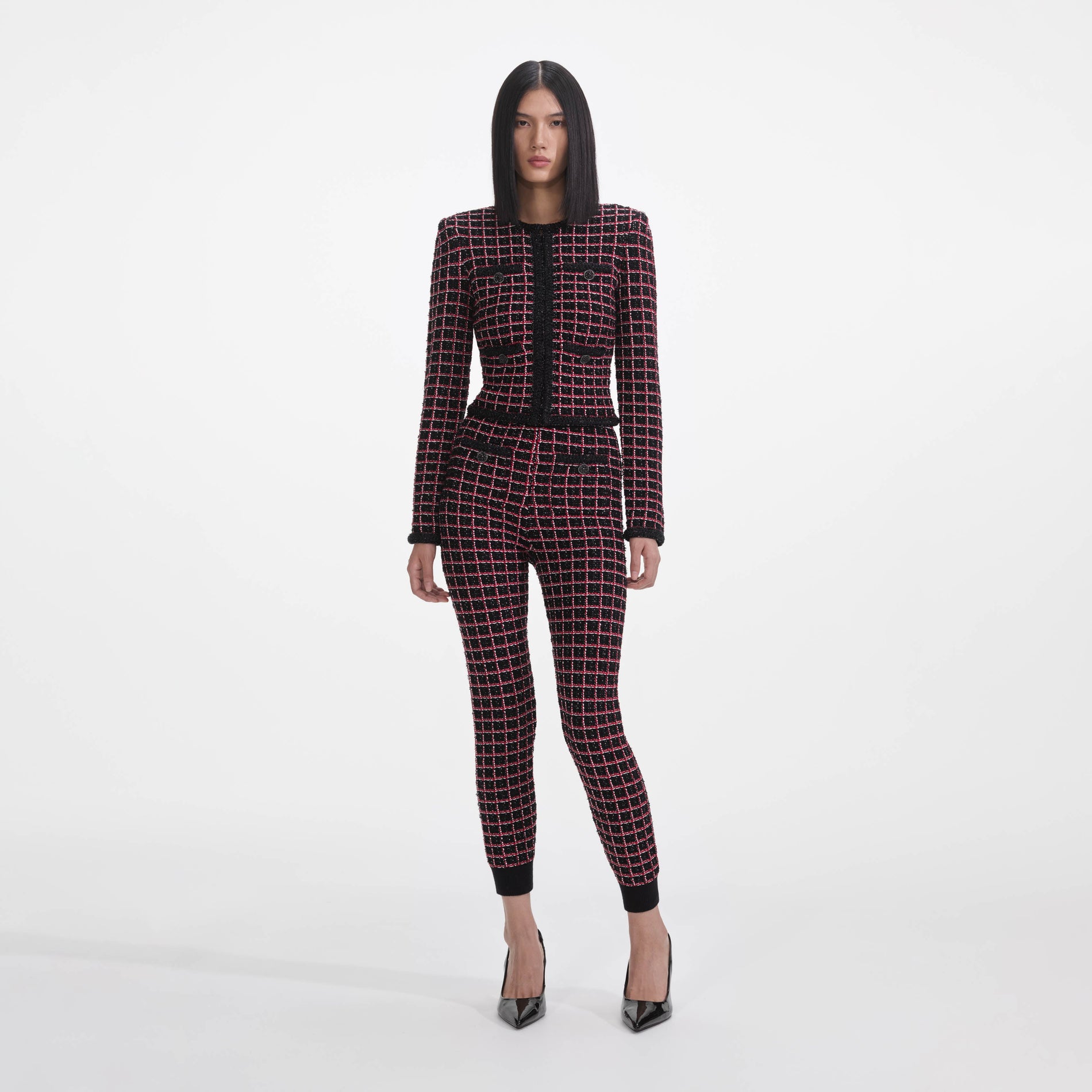 Front view of a woman wearing the Black And Red Check Knit Leggings