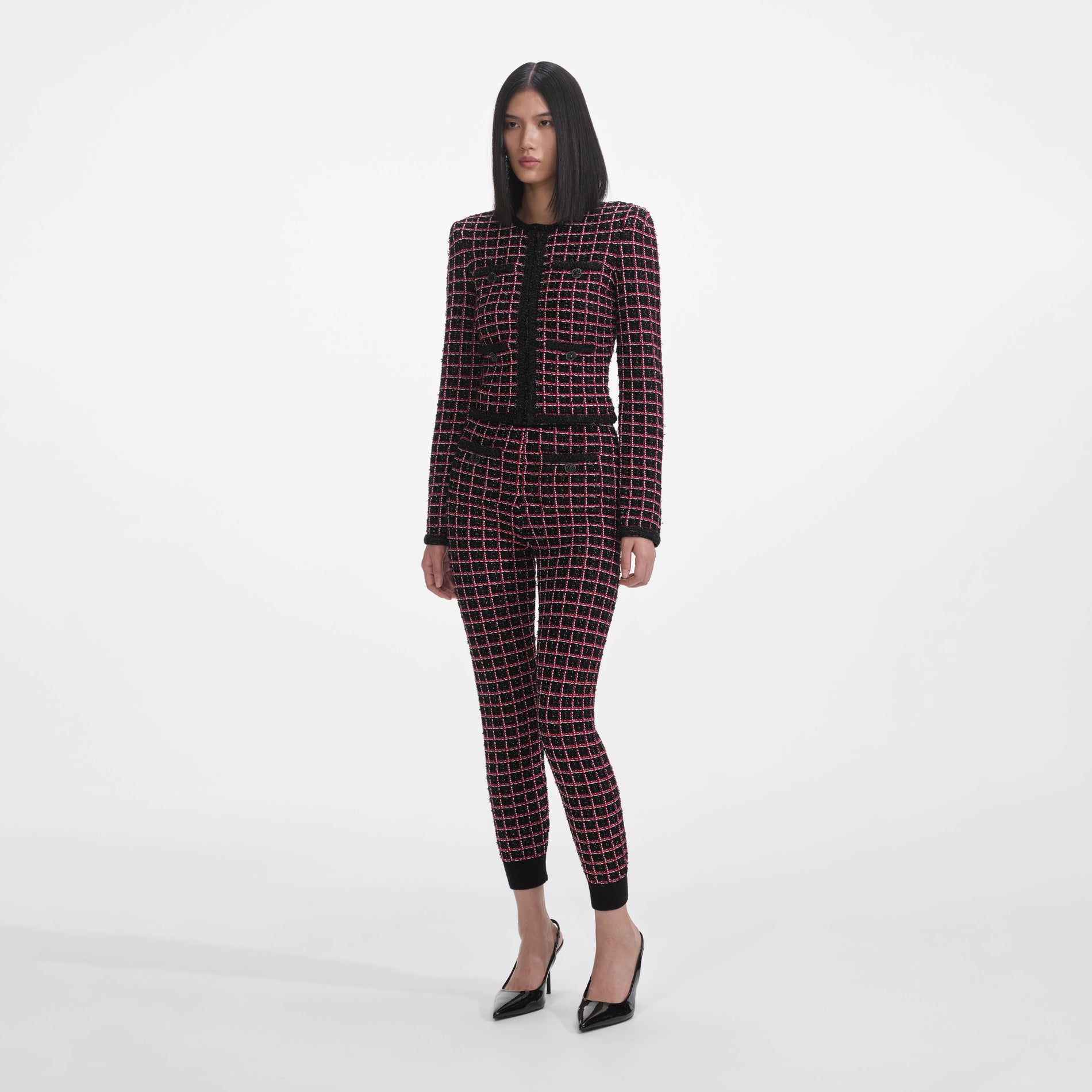 Side view of a woman wearing the Black And Red Check Cardigan