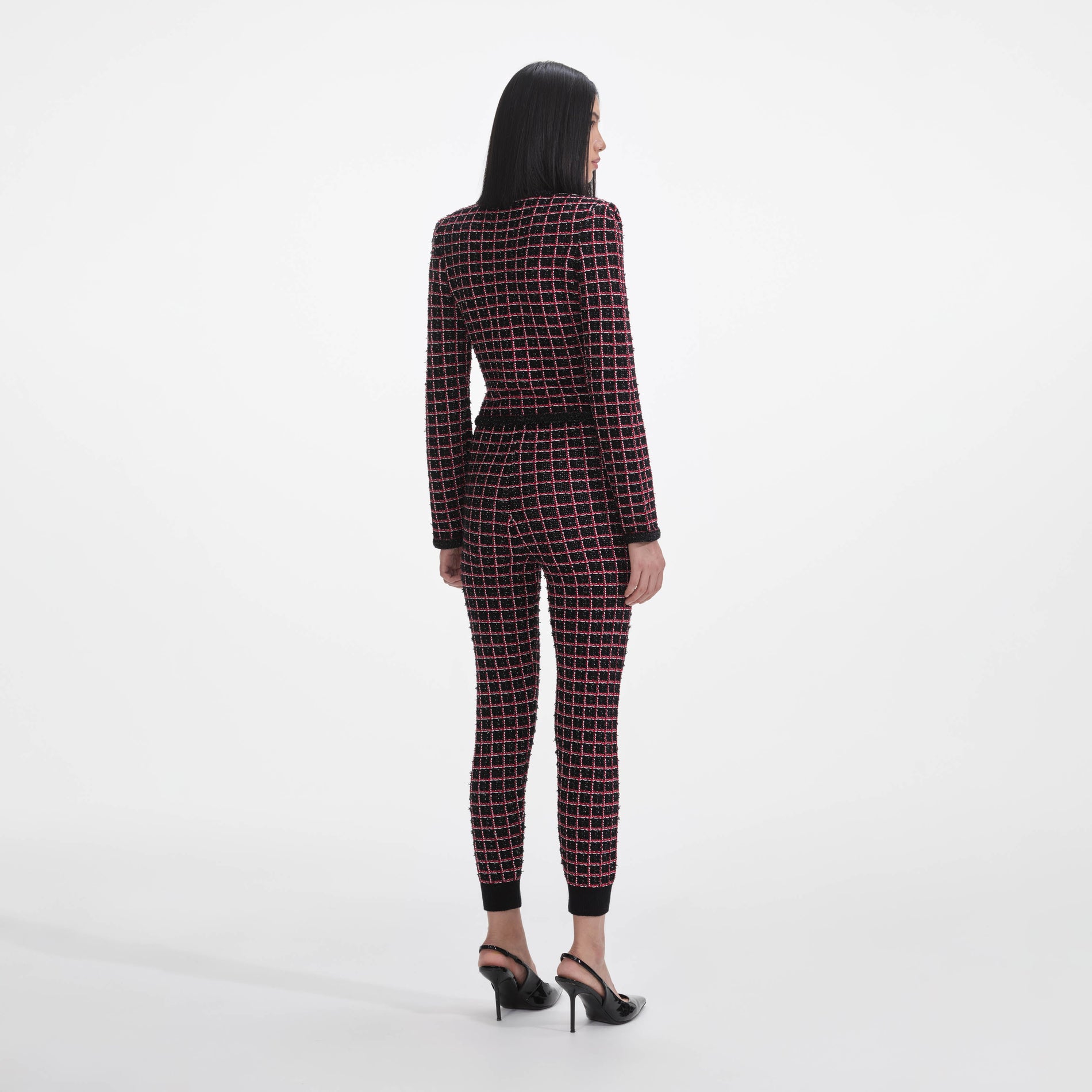 Back view of a woman wearing the Black And Red Check Knit Leggings