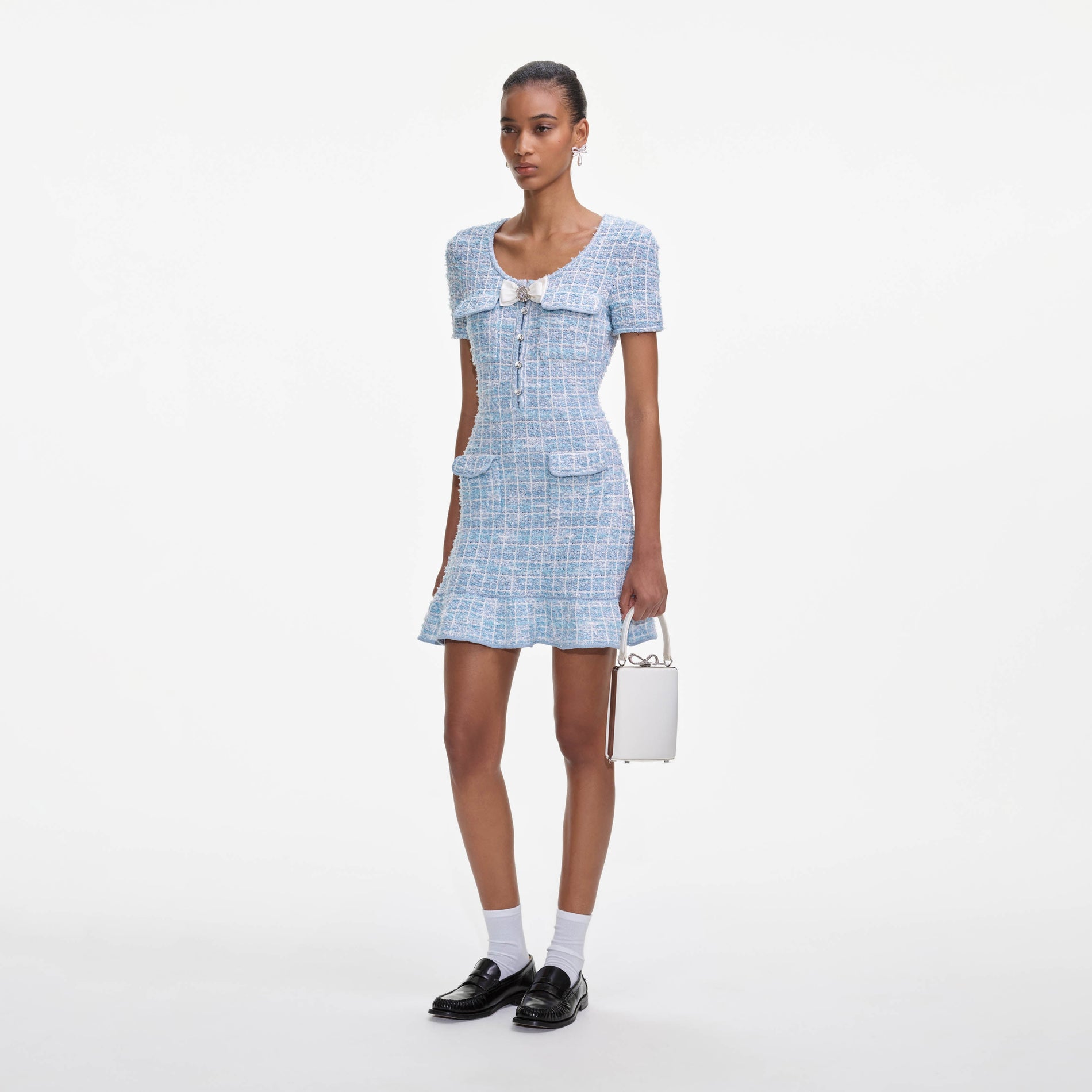 Side view of a woman wearing the Blue Check Knit Mini Dress