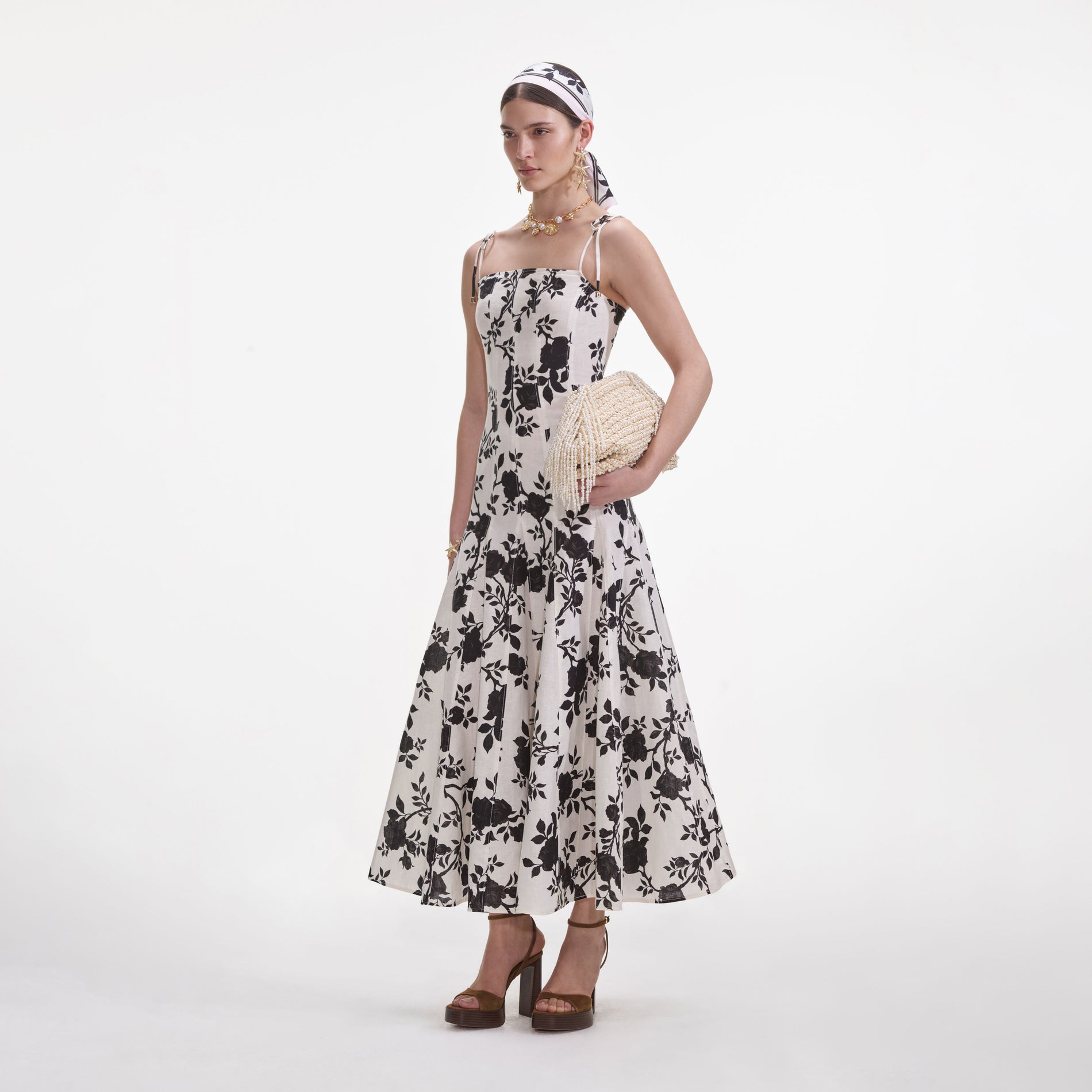 Side view of a woman wearing the Floral Print Linen Midi Dress