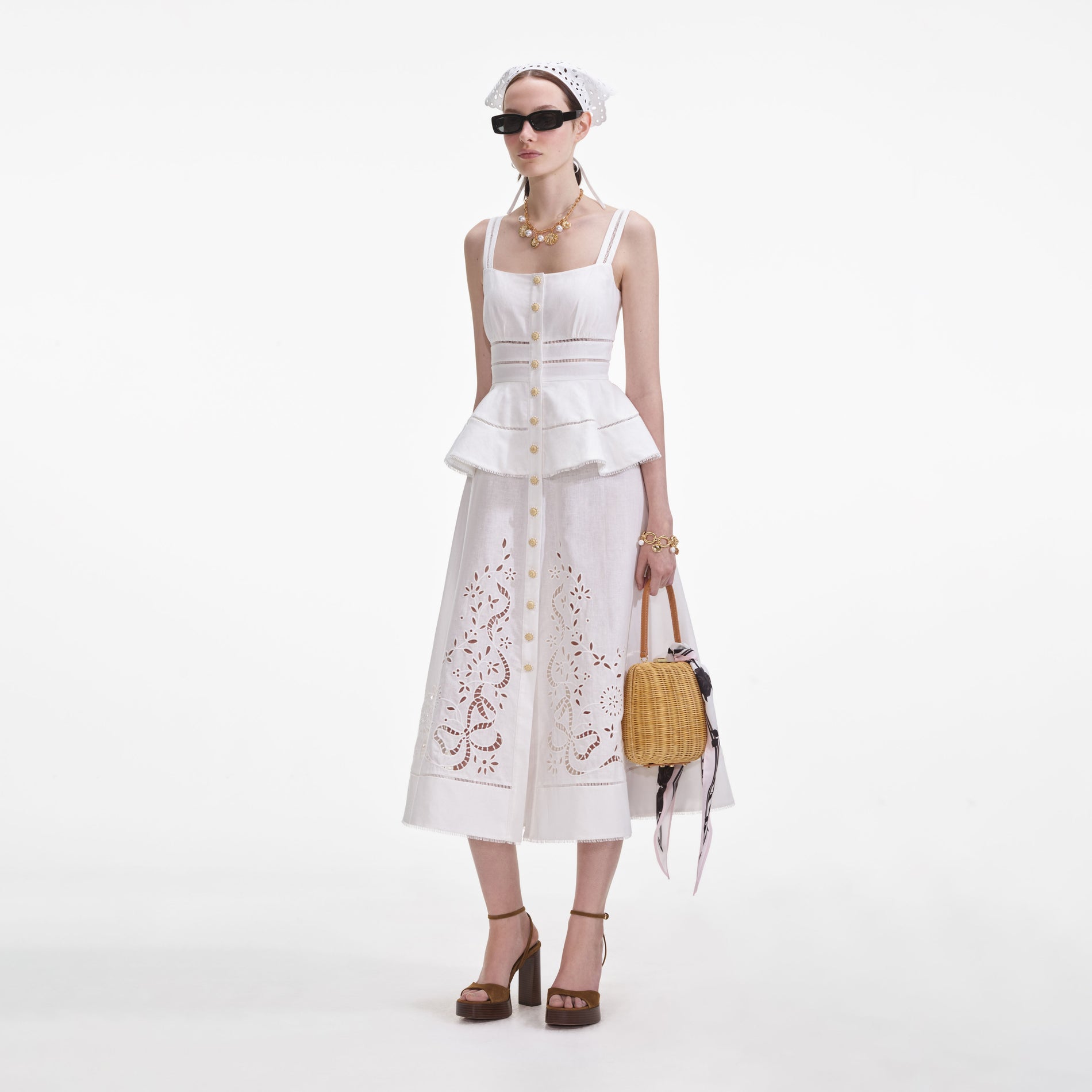 Side view of a woman wearing the Cream Linen Peplum Midi Dress