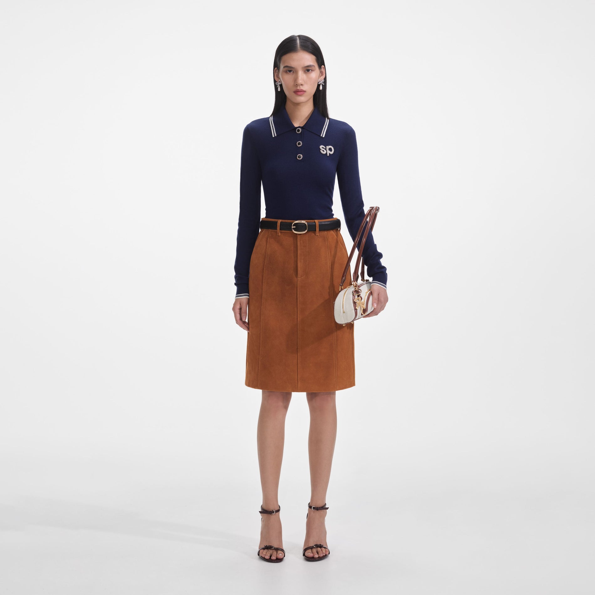 Front view of a woman wearing the Brown Suede Midi Skirt