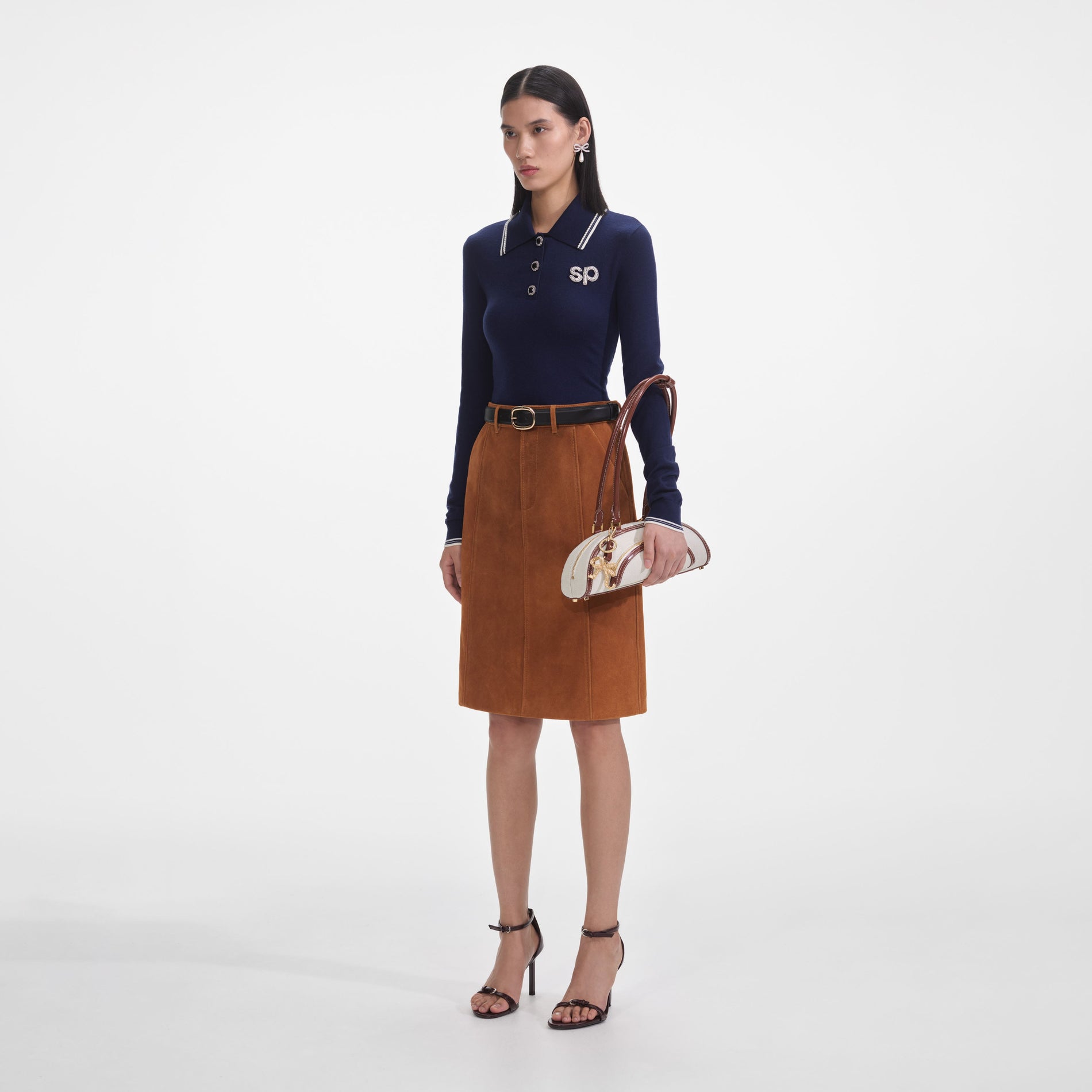 Side view of a woman wearing the Brown Suede Midi Skirt