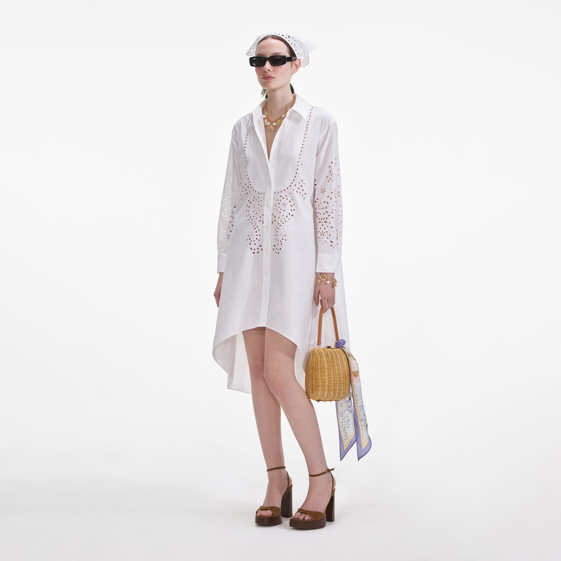 Side view of a woman wearing the White Cotton Embroidered Shirt Dress