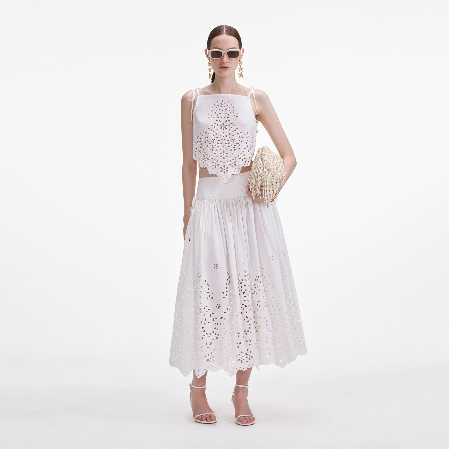 Front view of a woman wearing the White Cotton Embroidered Midi Skirt
