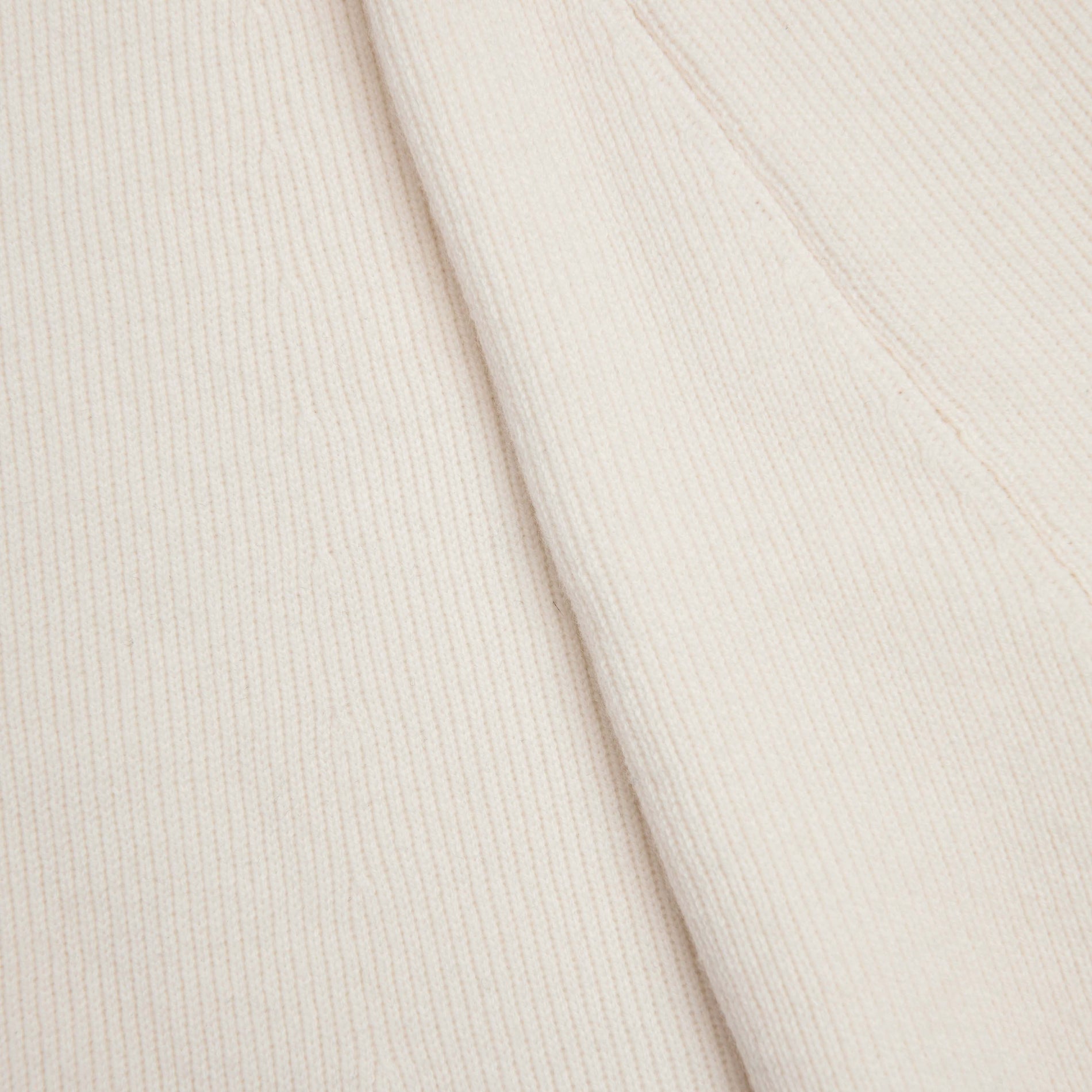 Side view of a woman wearing the Cream Flared Knit Midi Skirt