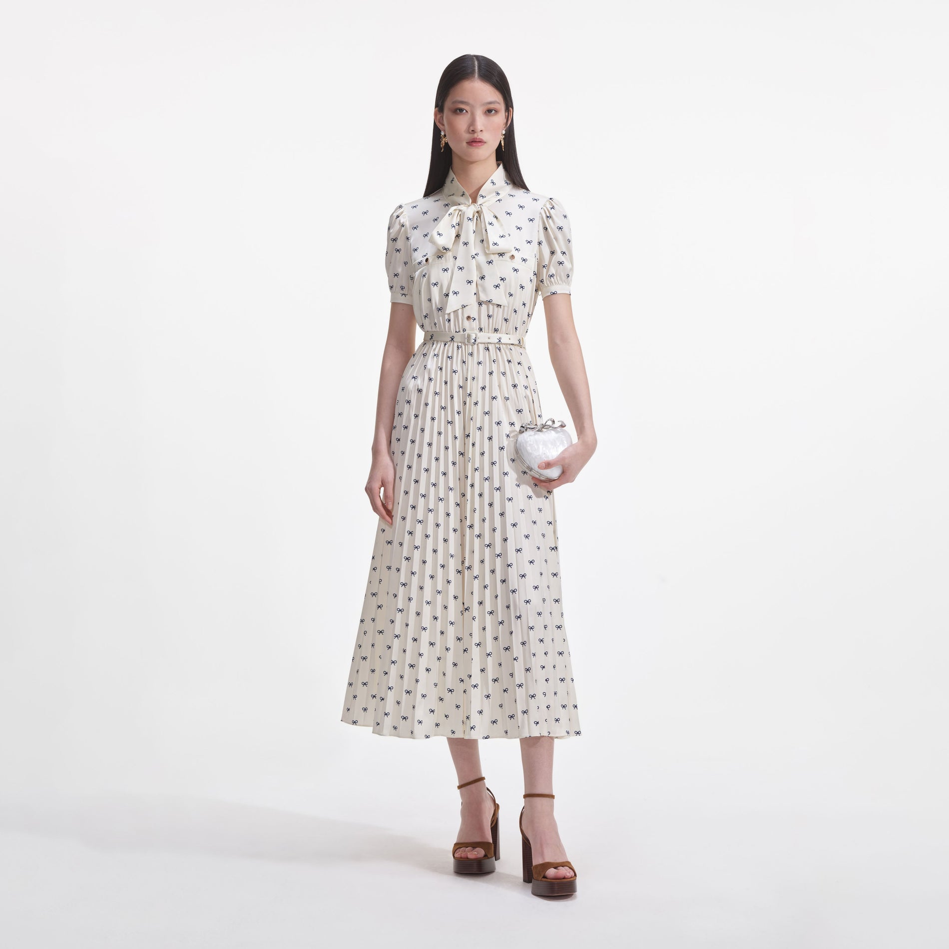 Front view of a woman wearing the Cream Satin Bow Print Midi Dress