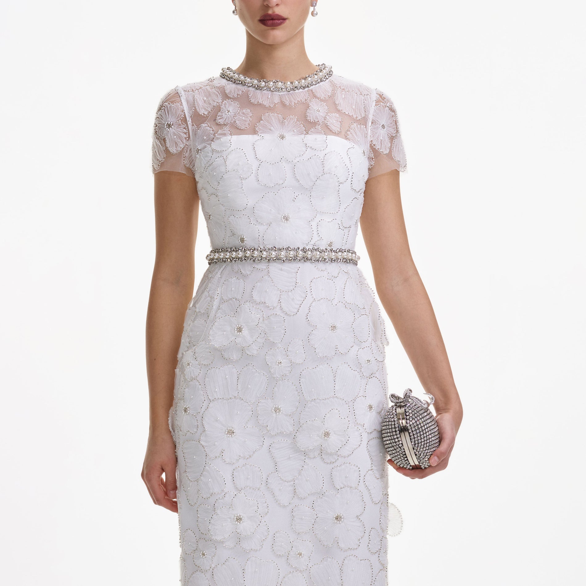 A close up of a woman wearing the White Embellished Tulle Midi Dress